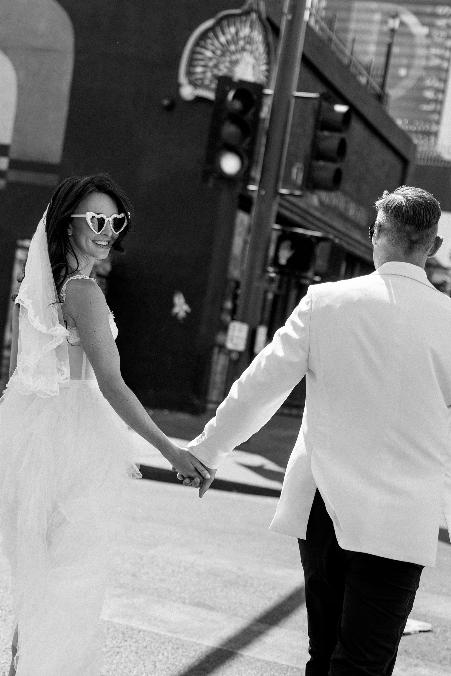 Artistic black and white photo sequence of dancing movements on a city street.