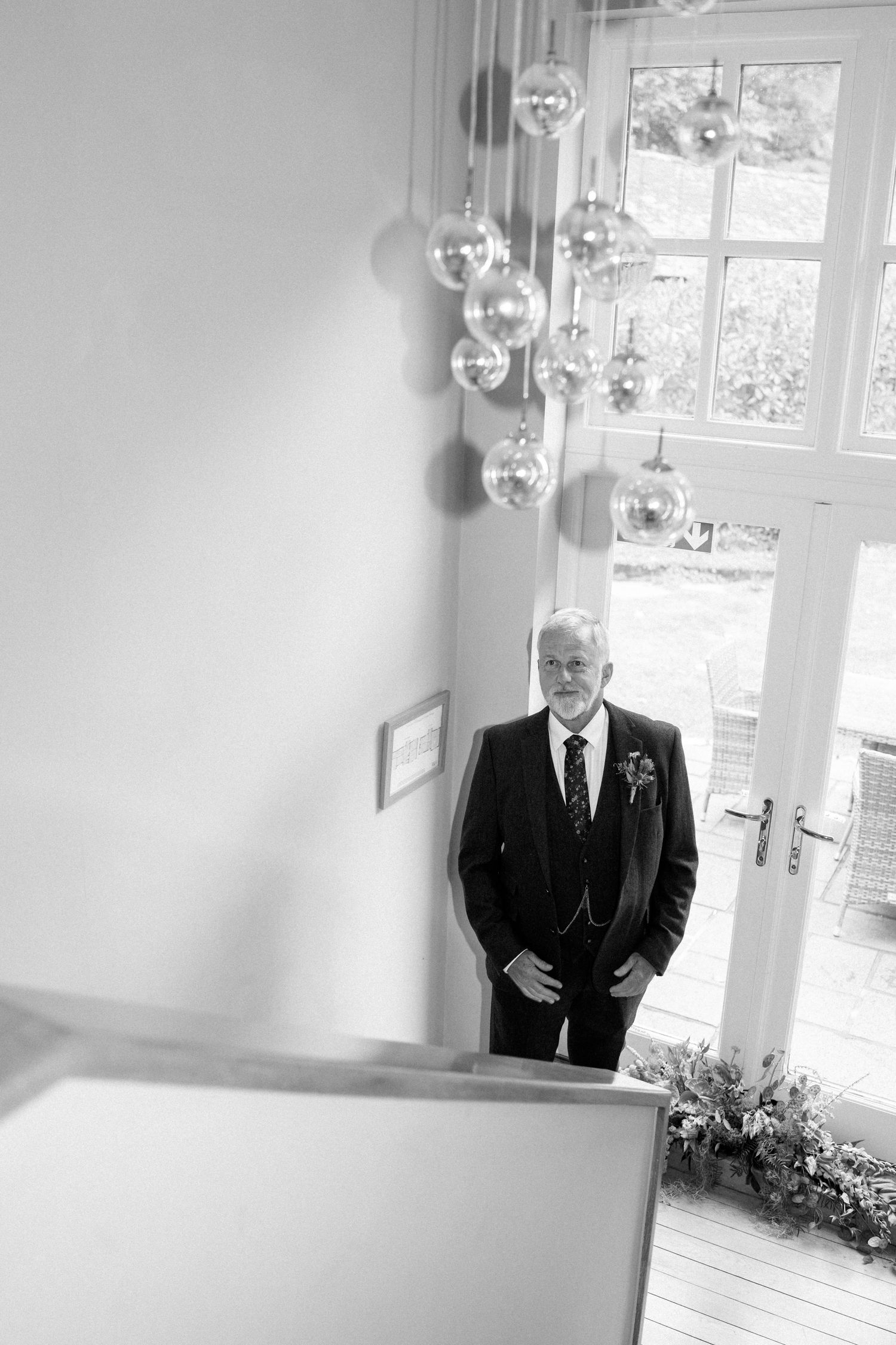 A black and white series of wedding preparation photos in an elegant indoor setting.