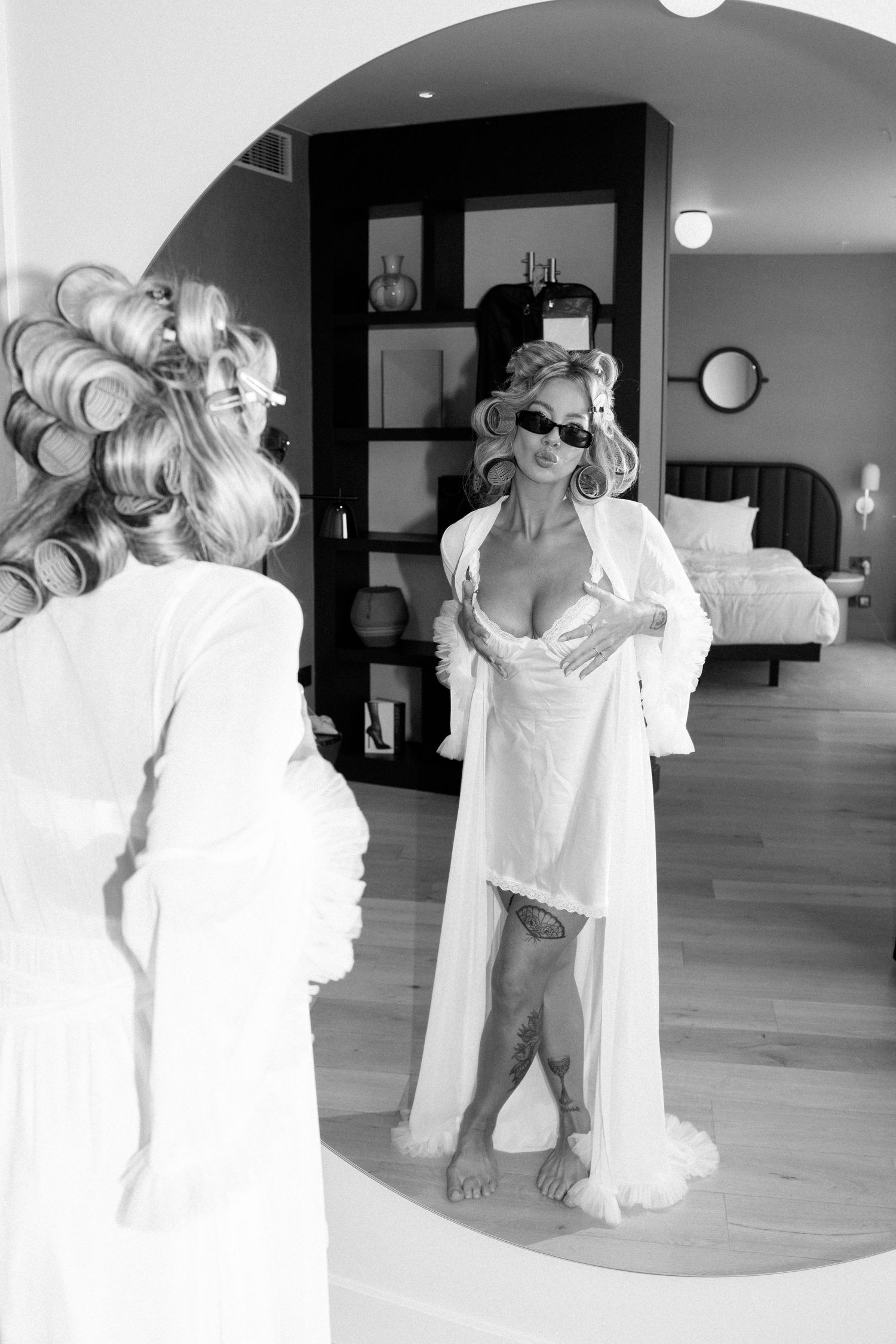 Series of black and white photos showing preparation moments with white dresses and robes.