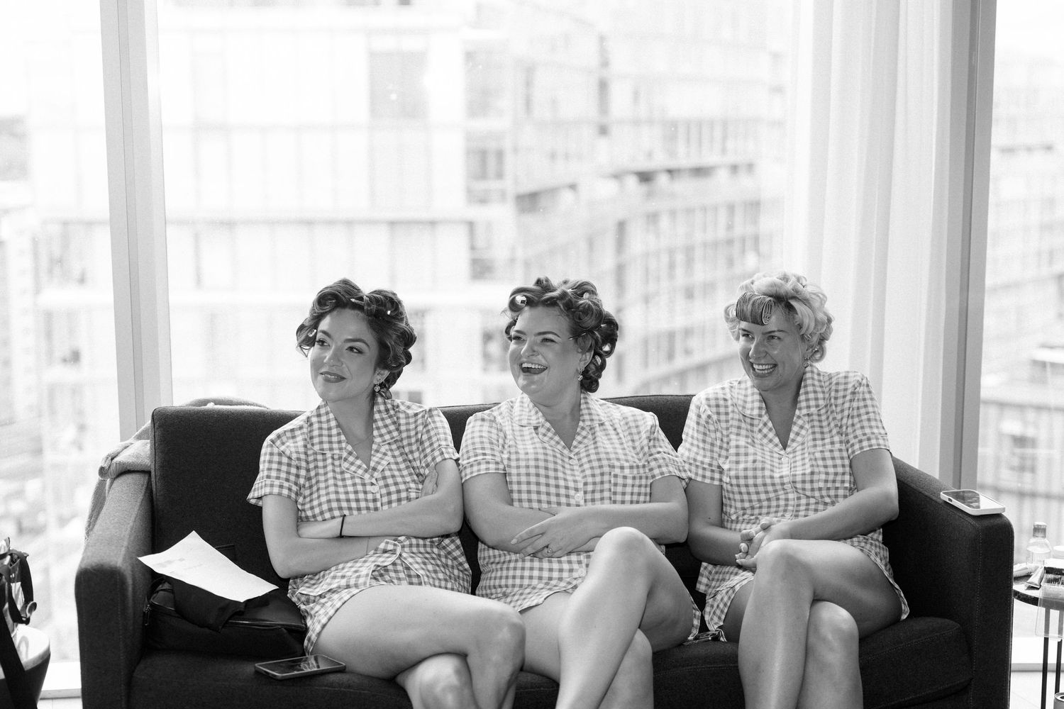 A series of black and white candid photographs showing people relaxing and laughing together on a couch.