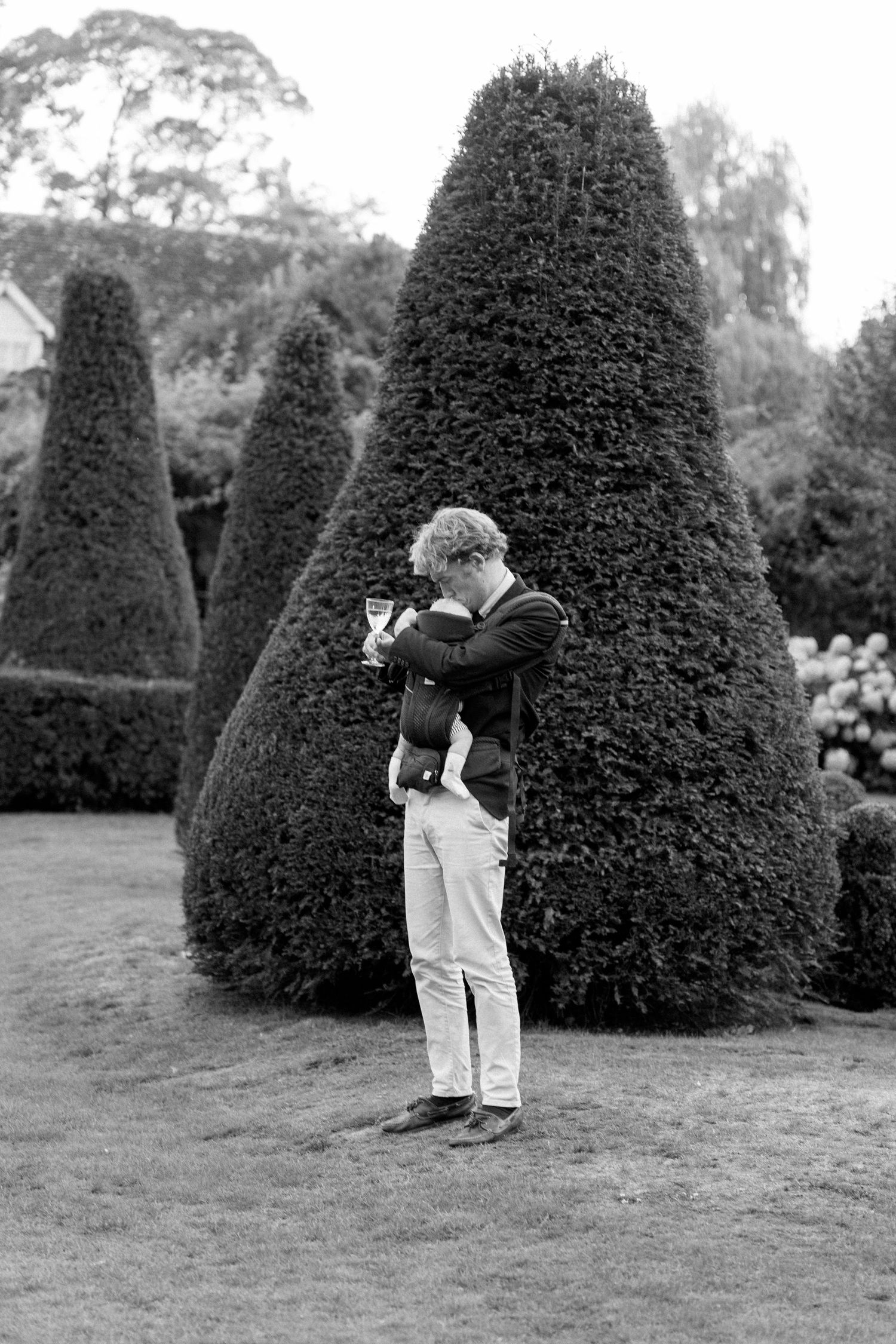 Black and white photo of formal garden with sculpted topiary bushes.