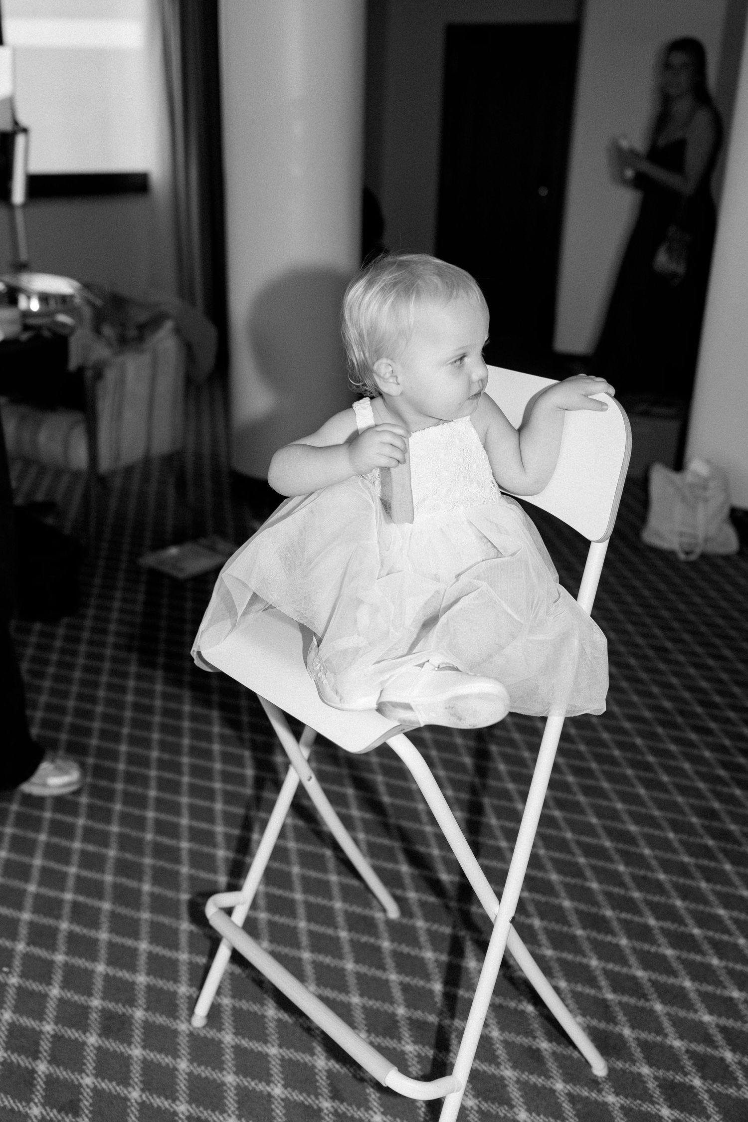 Series of black and white photos showing a small child in formal white attire.