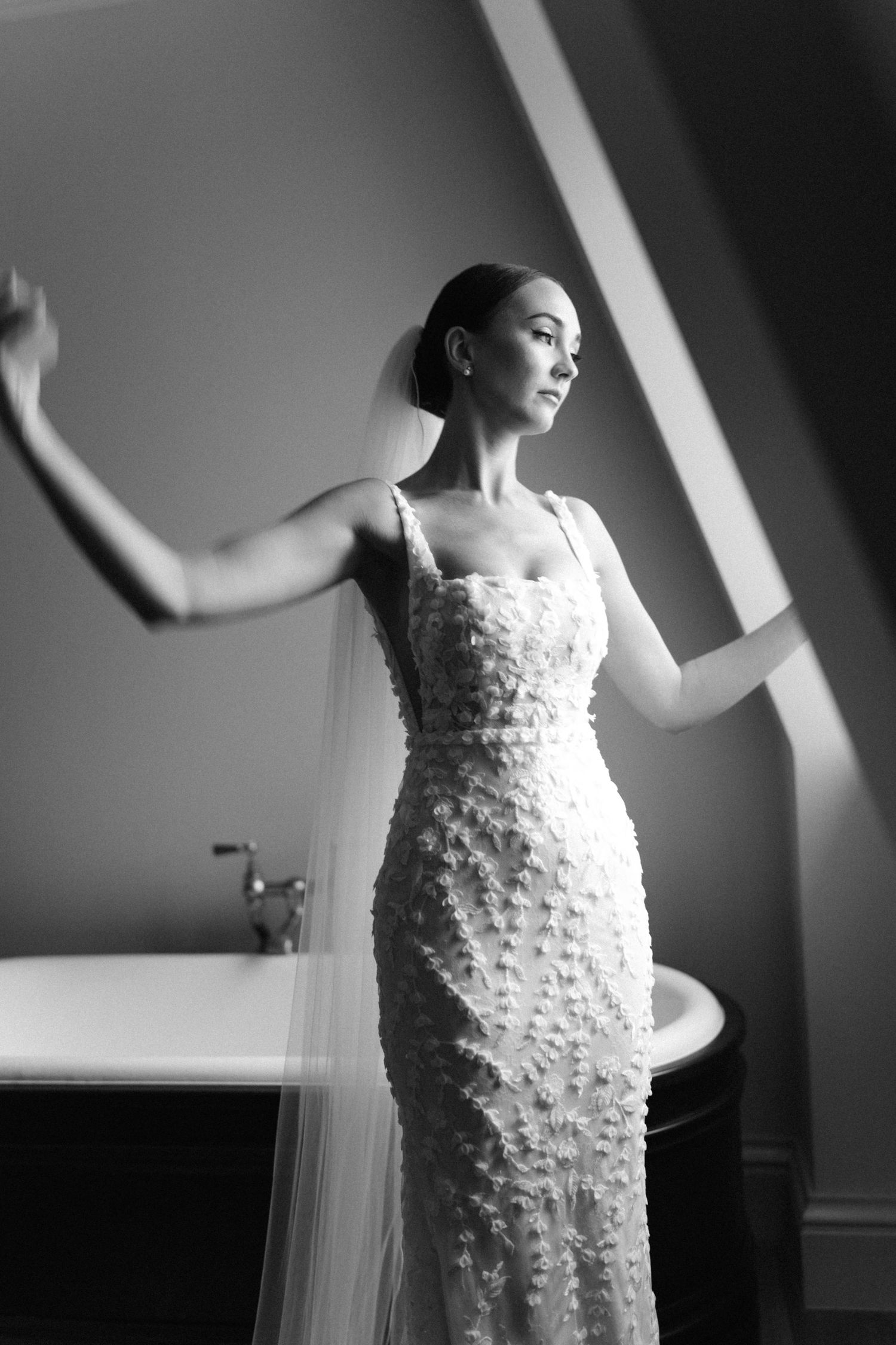 Dramatic black and white sequence of bride in textured gown with flowing movement.