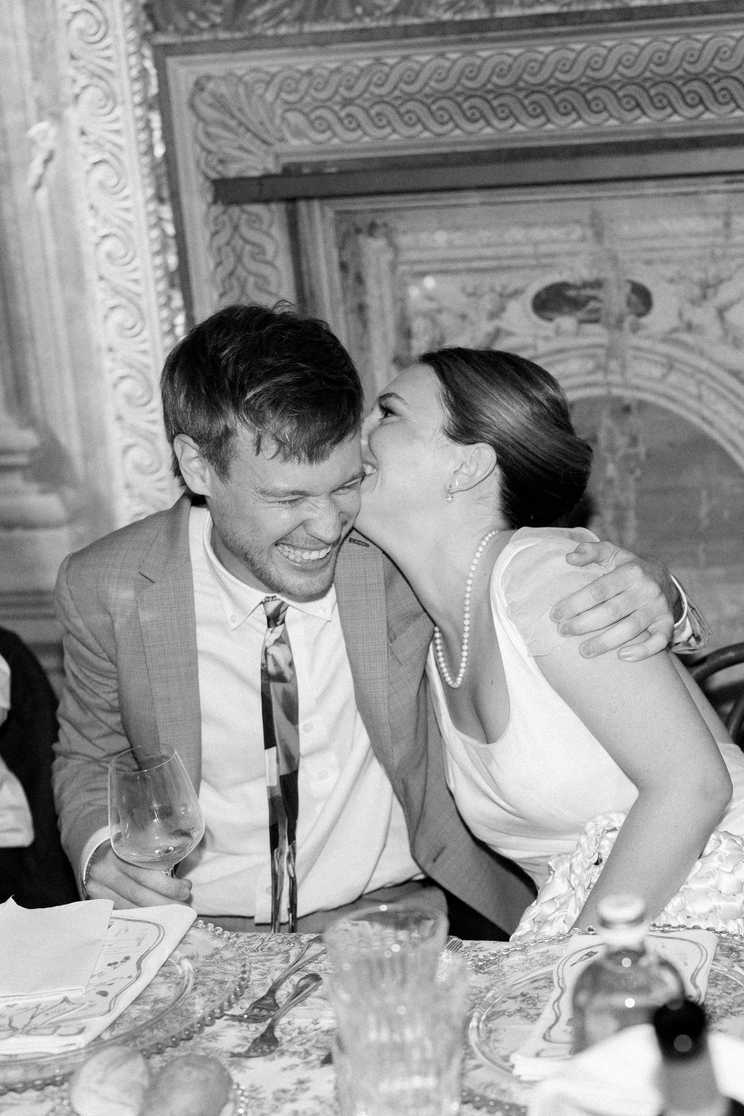 Intimate moments captured during an elegant dinner party in a historic venue.