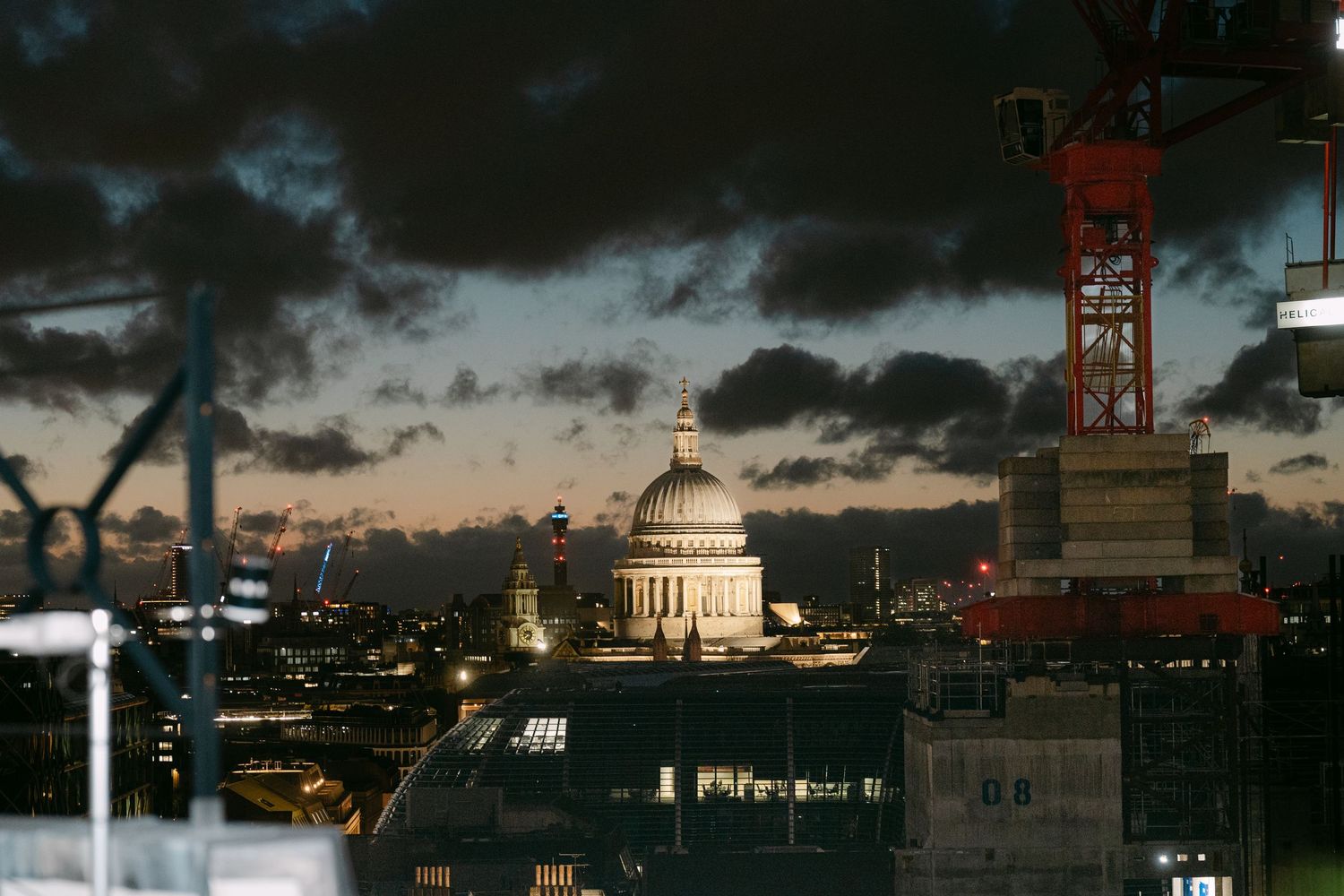 Dramatic stormy sky over London's historic cityscape at dusk.