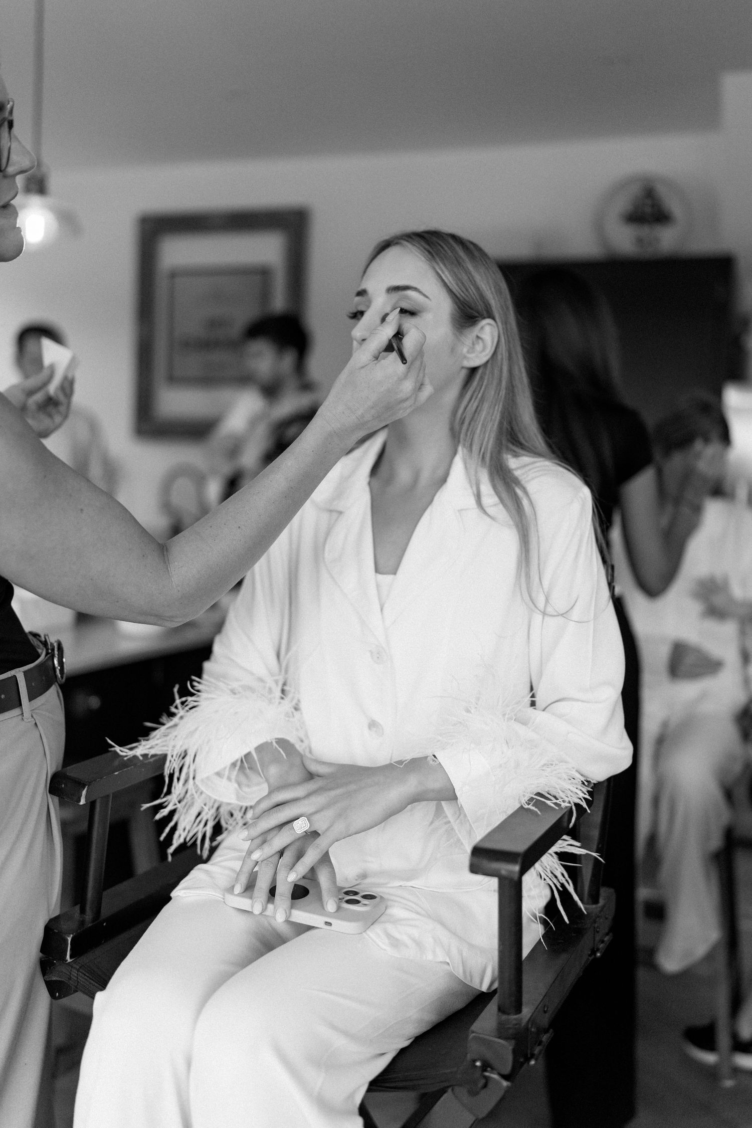 Black and white photograph of someone in a white robe getting ready.
