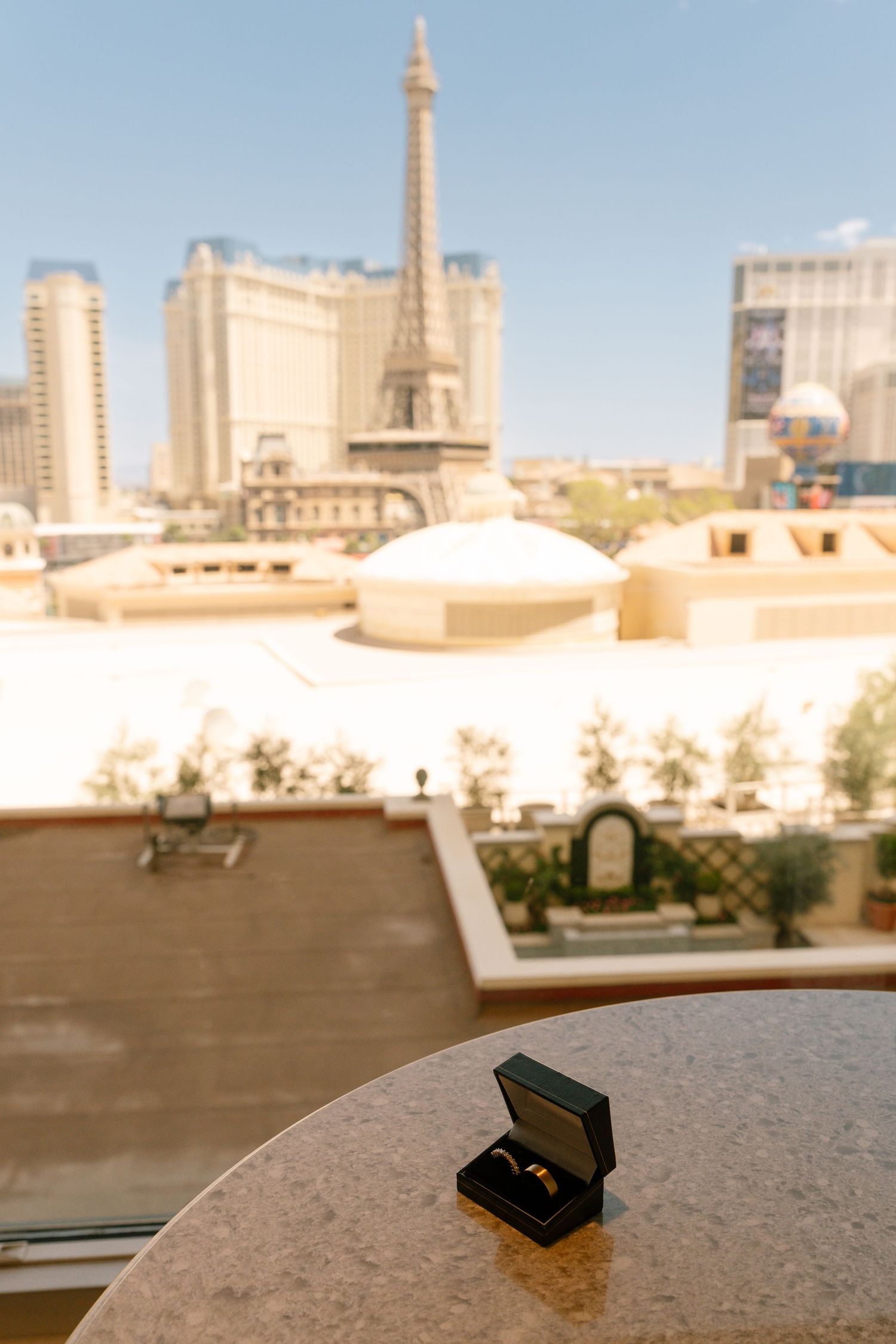 Ring box displayed with Las Vegas Paris Hotel Eiffel Tower replica in background.