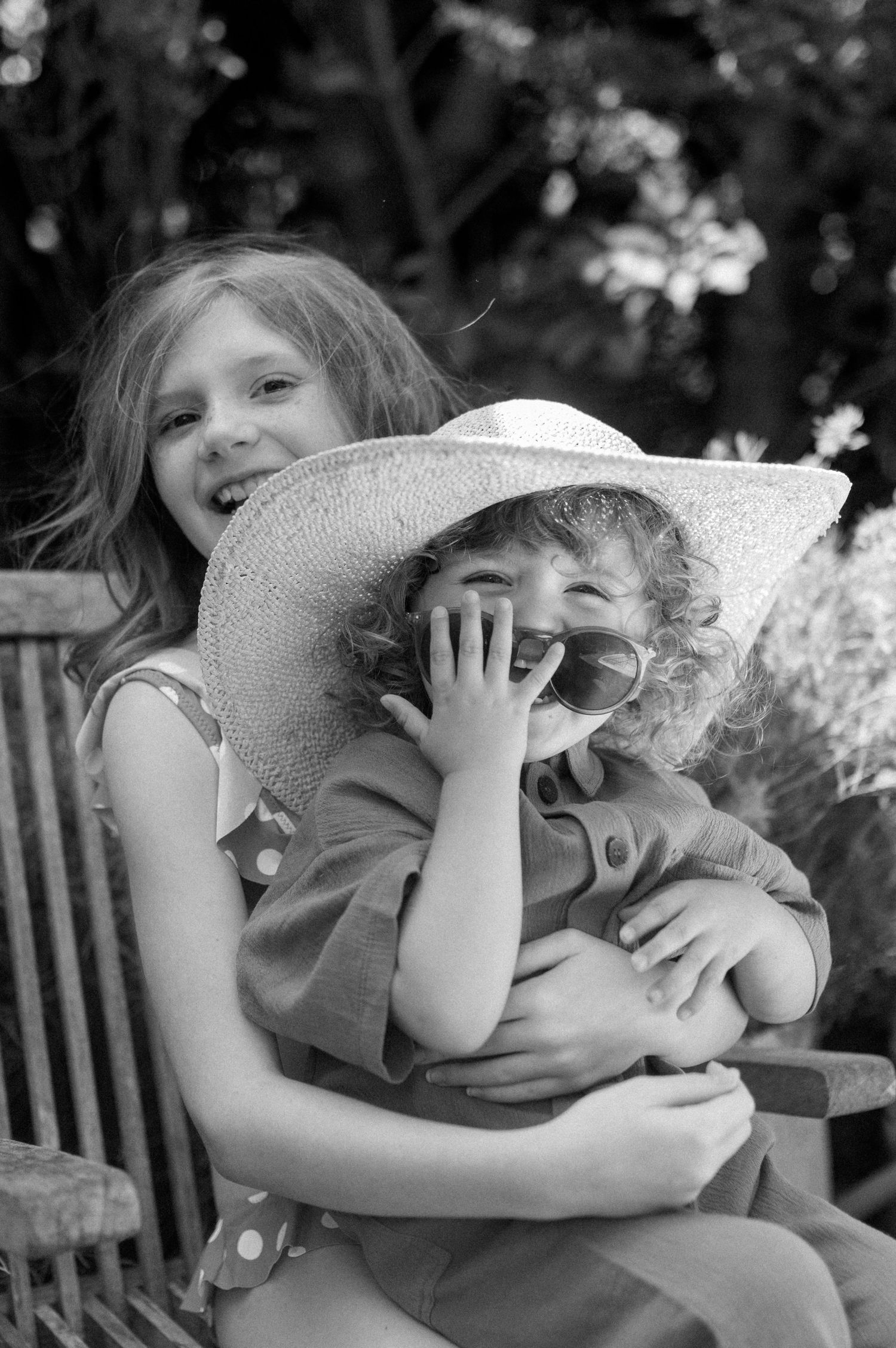 Black and white series of joyful moments with a large sun hat.