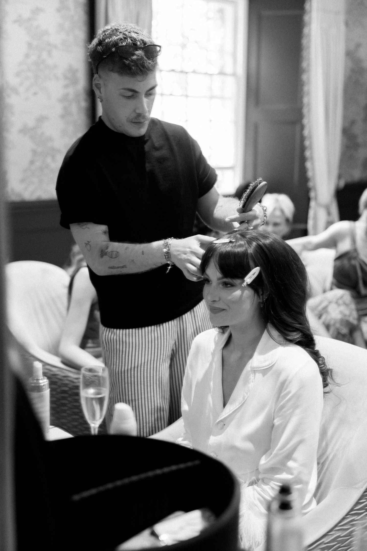 Hairstylist working on client's hair in modern salon setting.