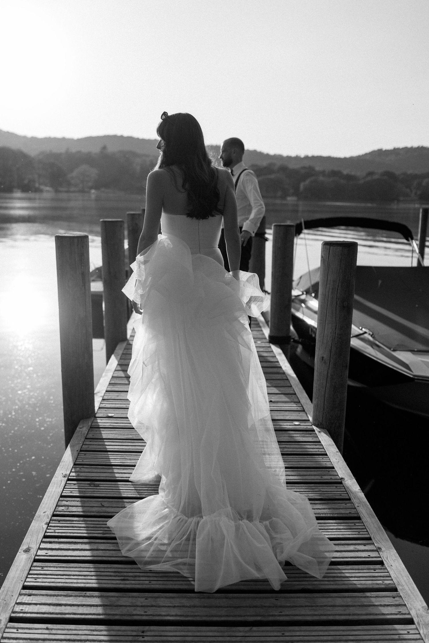 Dramatic sunset photos on a wooden pier with flowing white dress.