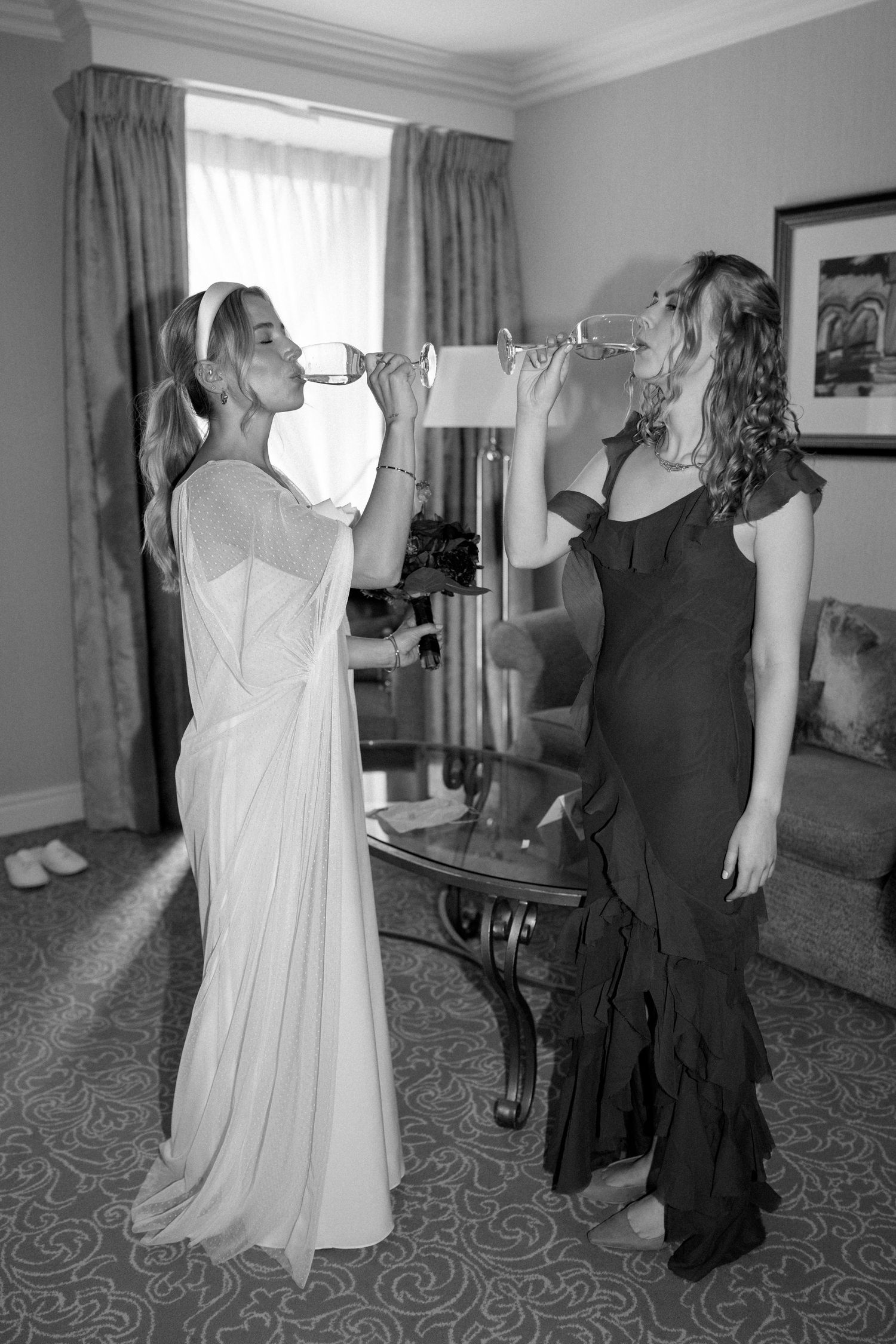 Candid moments of wedding preparation with bride and attendants in hotel suite.