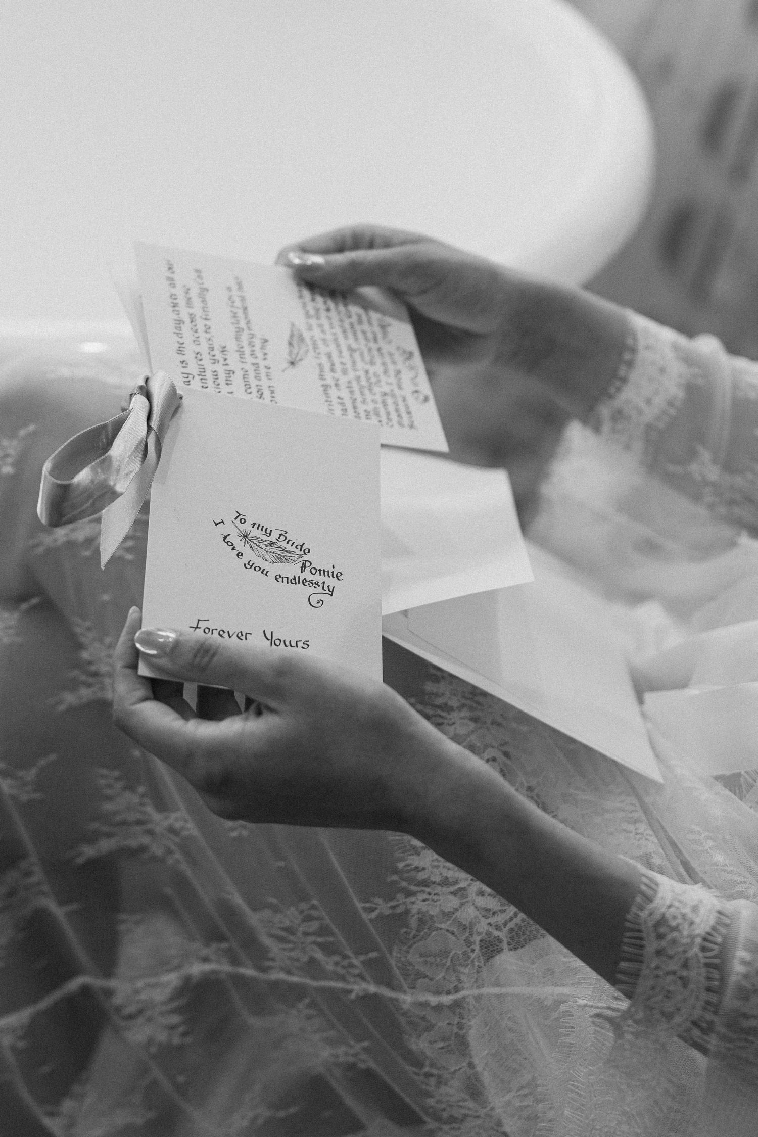 Bride reading a heartfelt letter signed Forever Yours while dressed in her wedding gown.