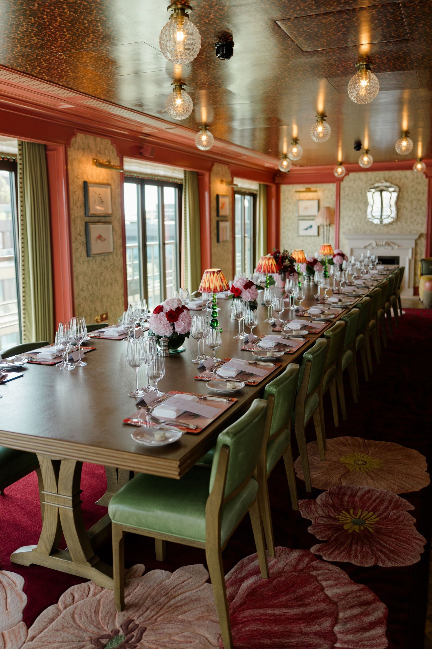Elegant private dining room set for wedding reception with floral decor.