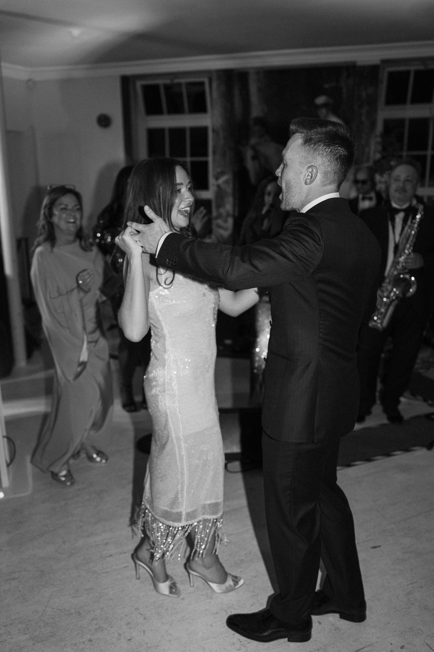 Black and white photo of bride and groom sharing a first dance at their wedding.