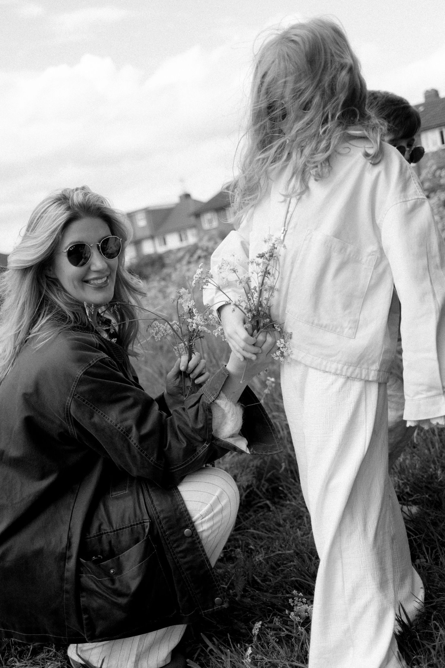 Artistic black and white photos showing people interacting in an outdoor setting.