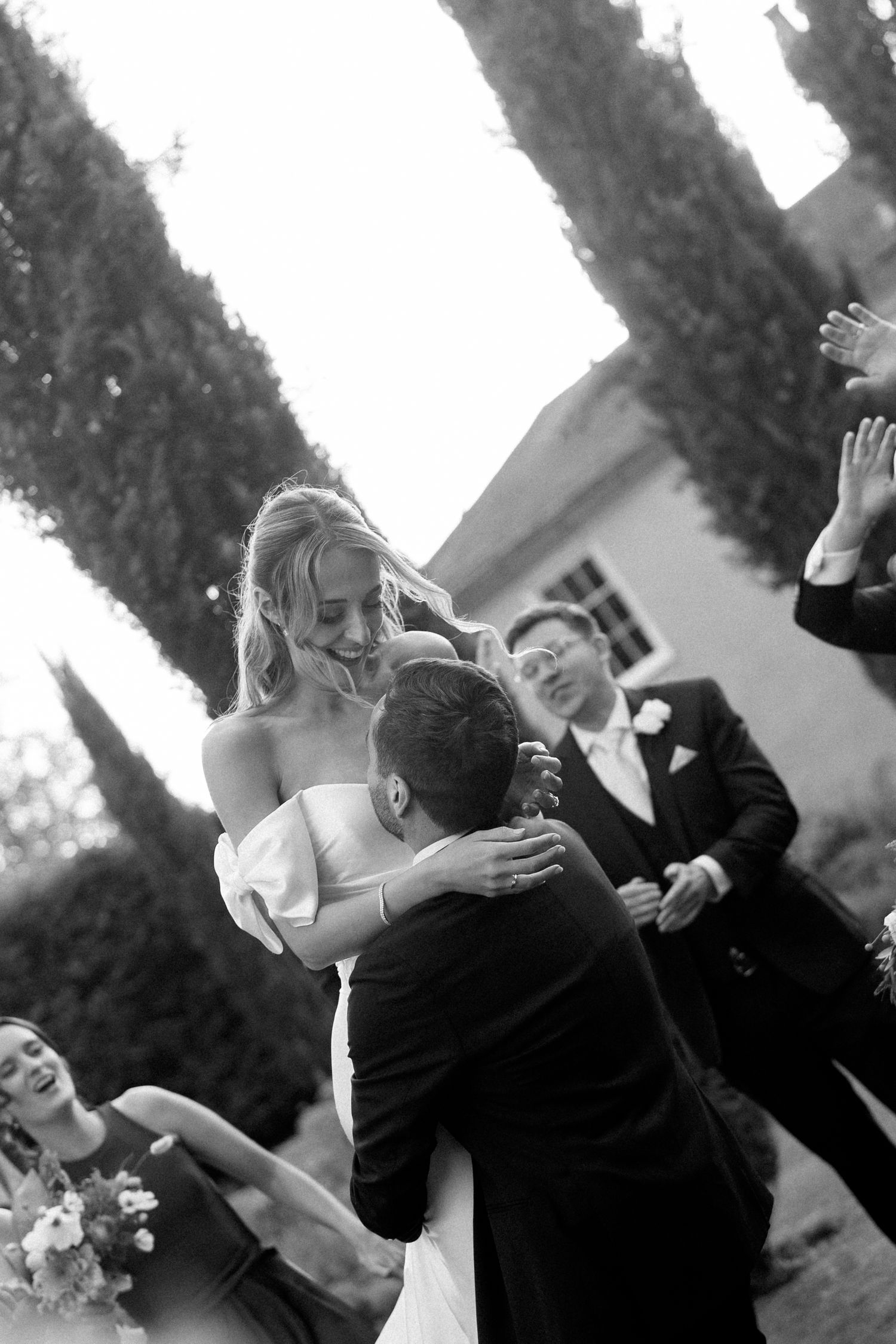 Black and white sequence of a joyful wedding celebration moment outdoors.