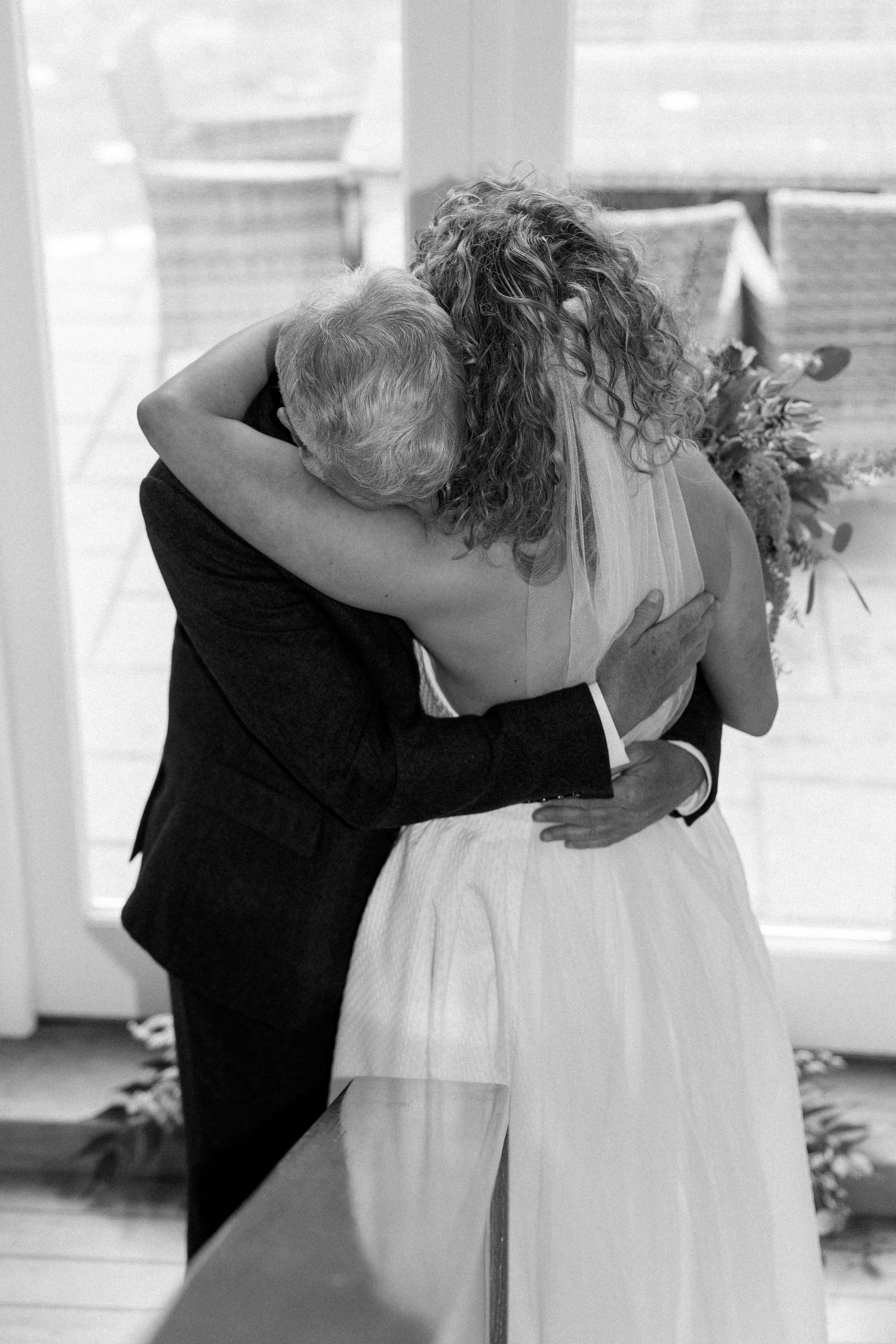 Black and white candid moments from a wedding ceremony.