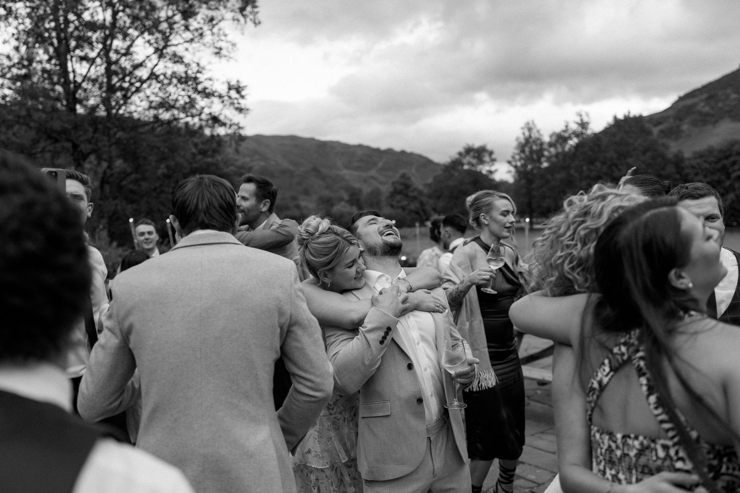 Wedding guests forming a circle during outdoor celebration.