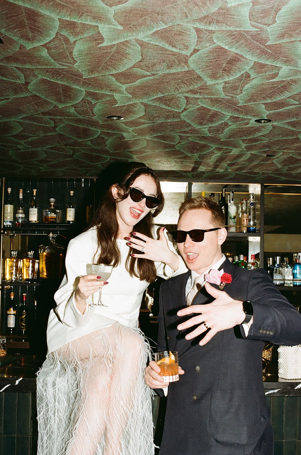 A series of candid photos showing people in sunglasses laughing and socializing at a bar with a decorative patterned ceiling.