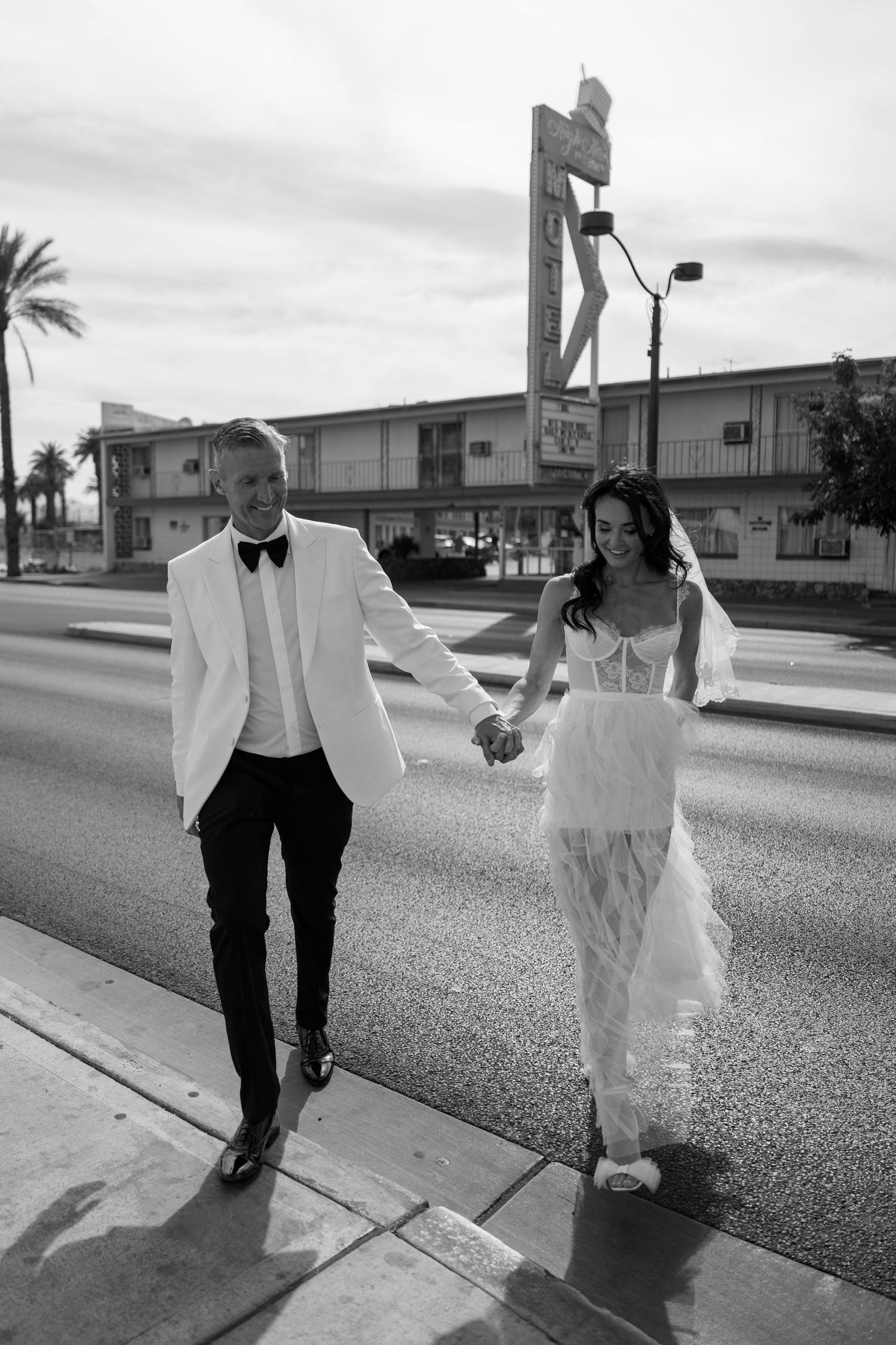 Black and white photos of couple dancing on outdoor street.