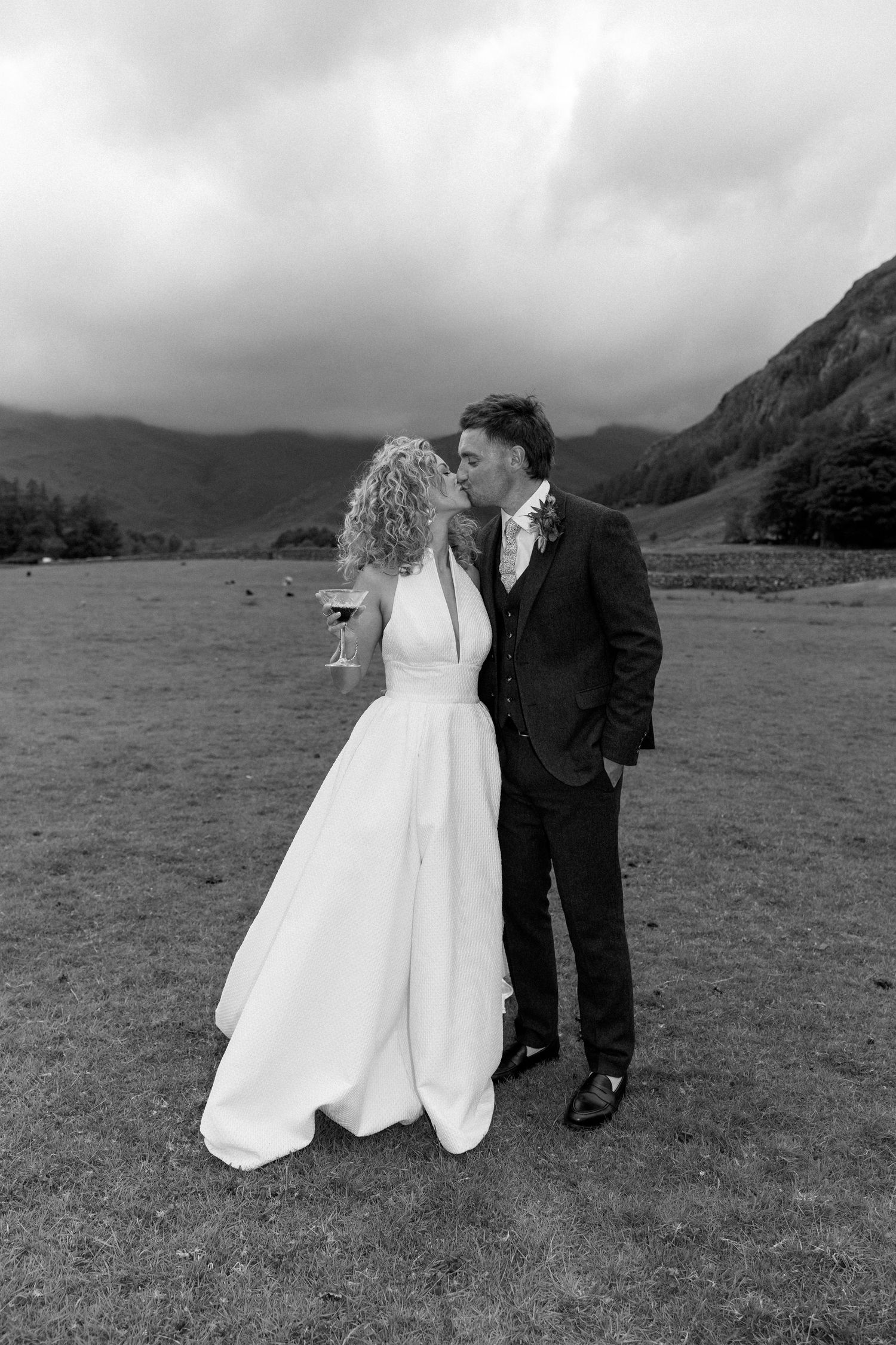 Romantic black and white wedding portrait in mountain valley setting.