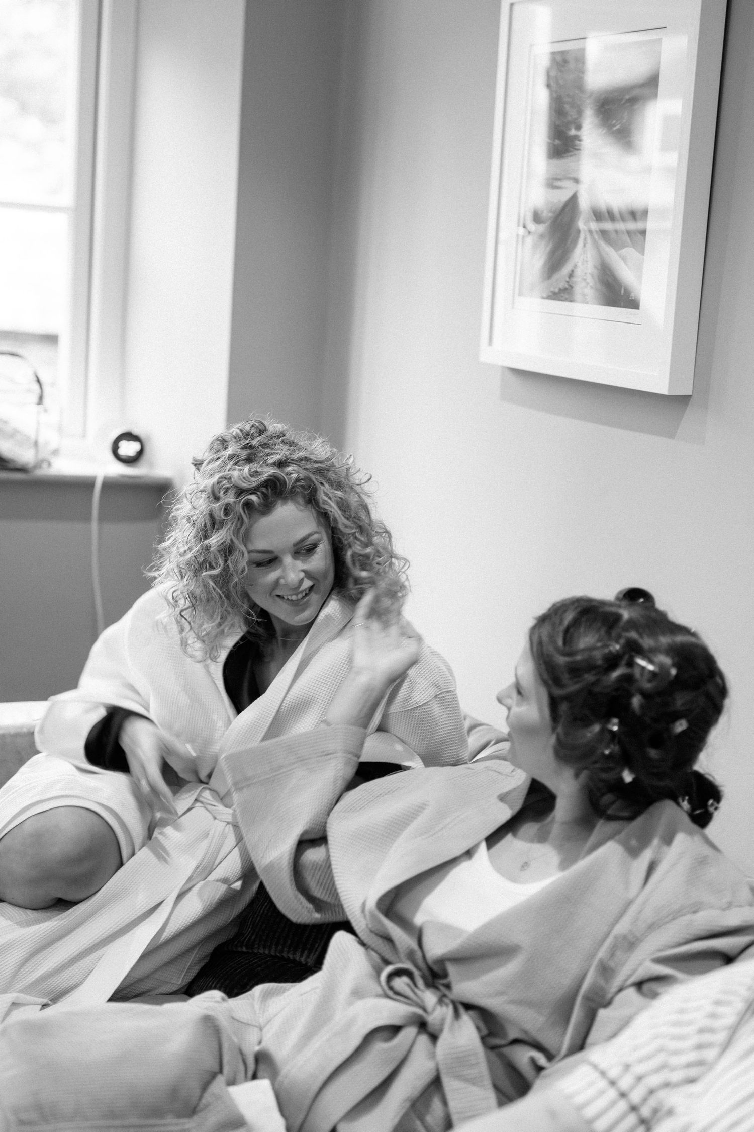 Black and white sequence of playful moments in bed showing joyful interaction and laughter.