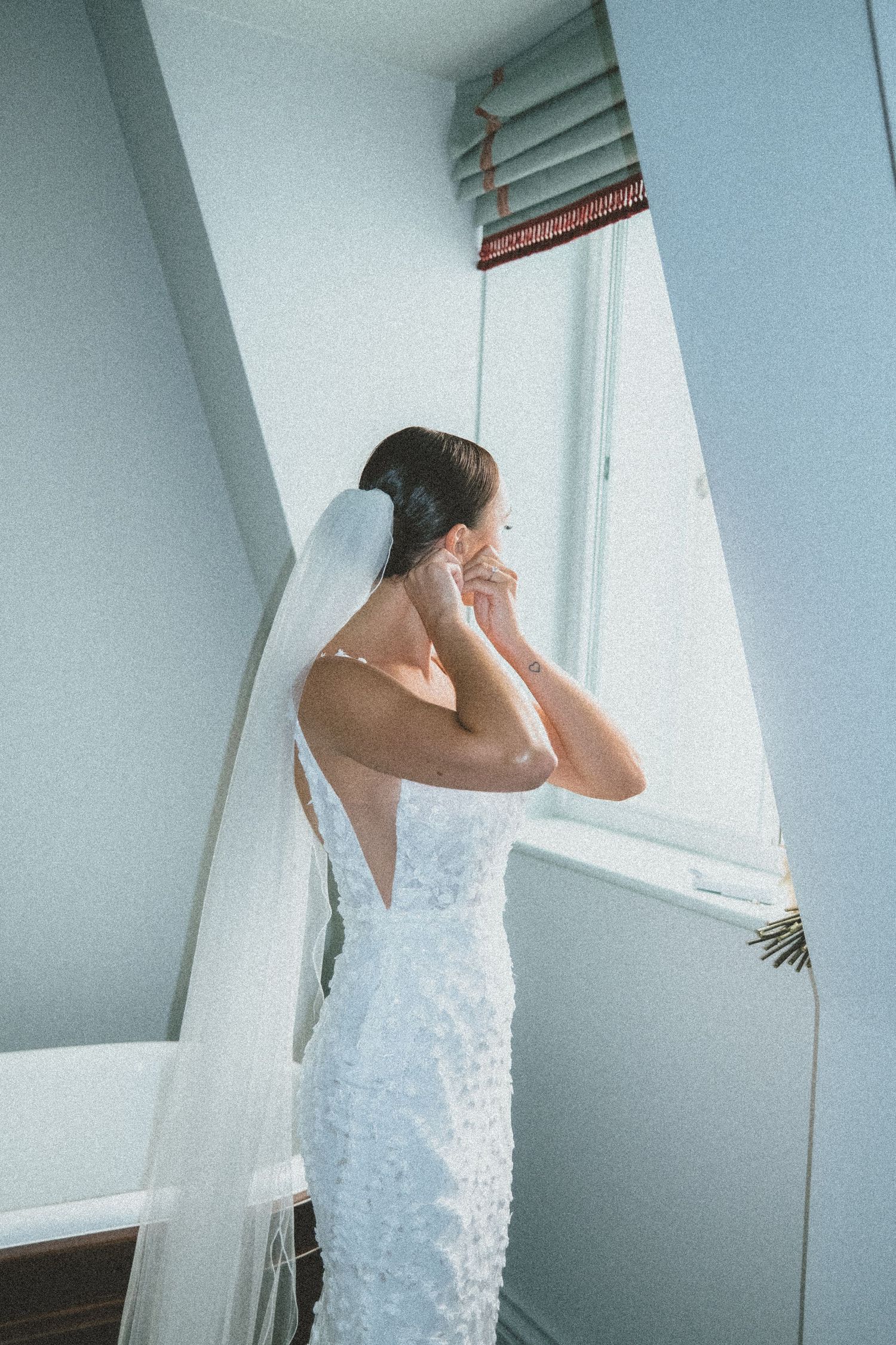 A series of four photos showing someone in a white dress looking out through a sunlit window.