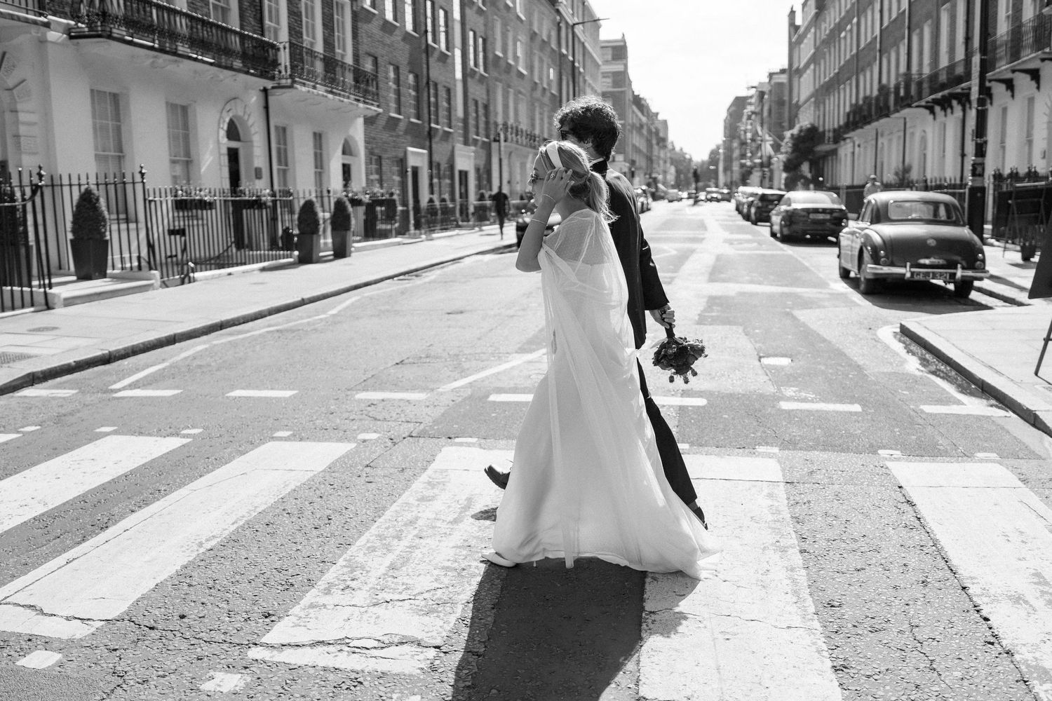 Urban wedding photography series showing couple walking down a historic street.