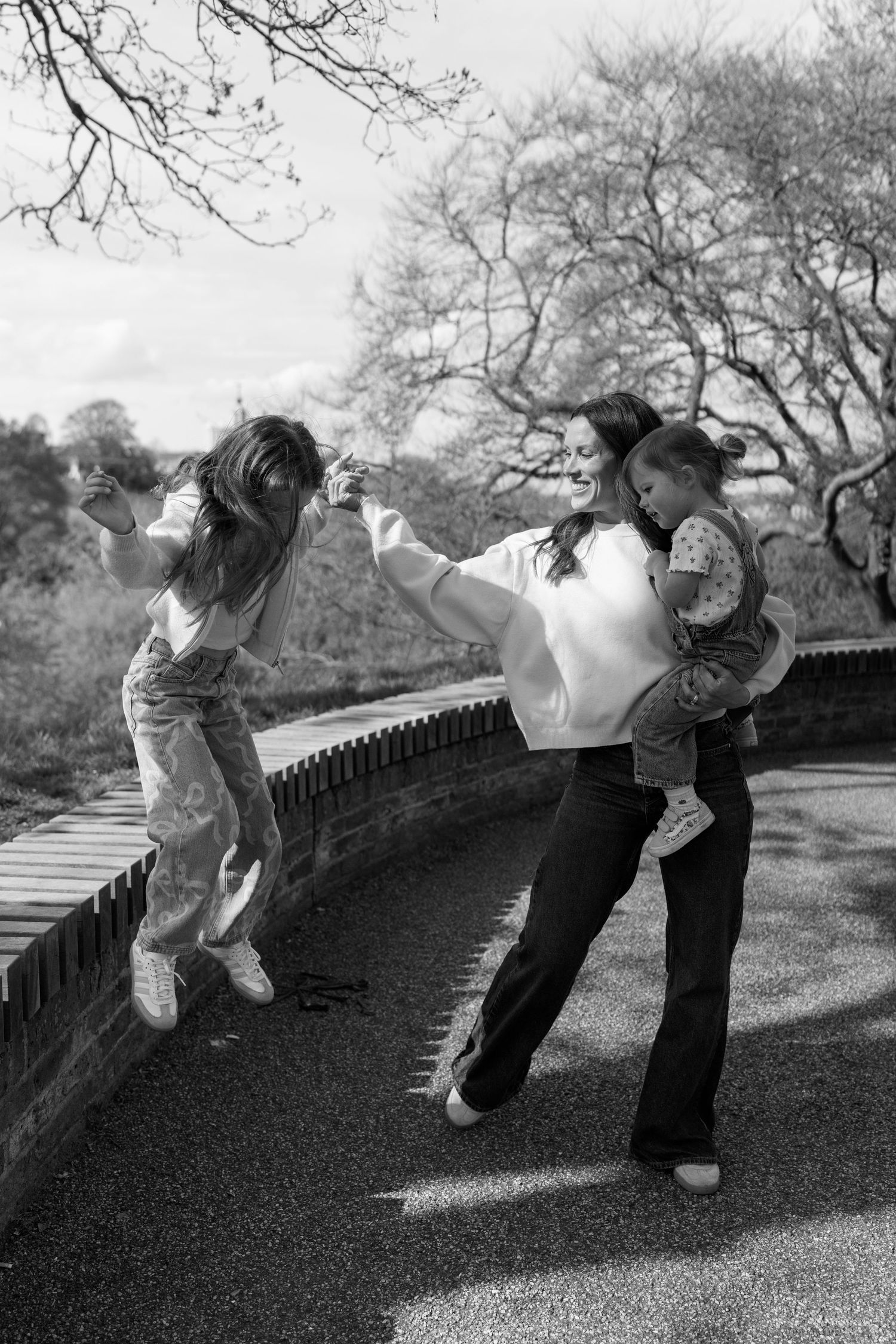 A playful sequence of black and white photos showing movement along a railing.