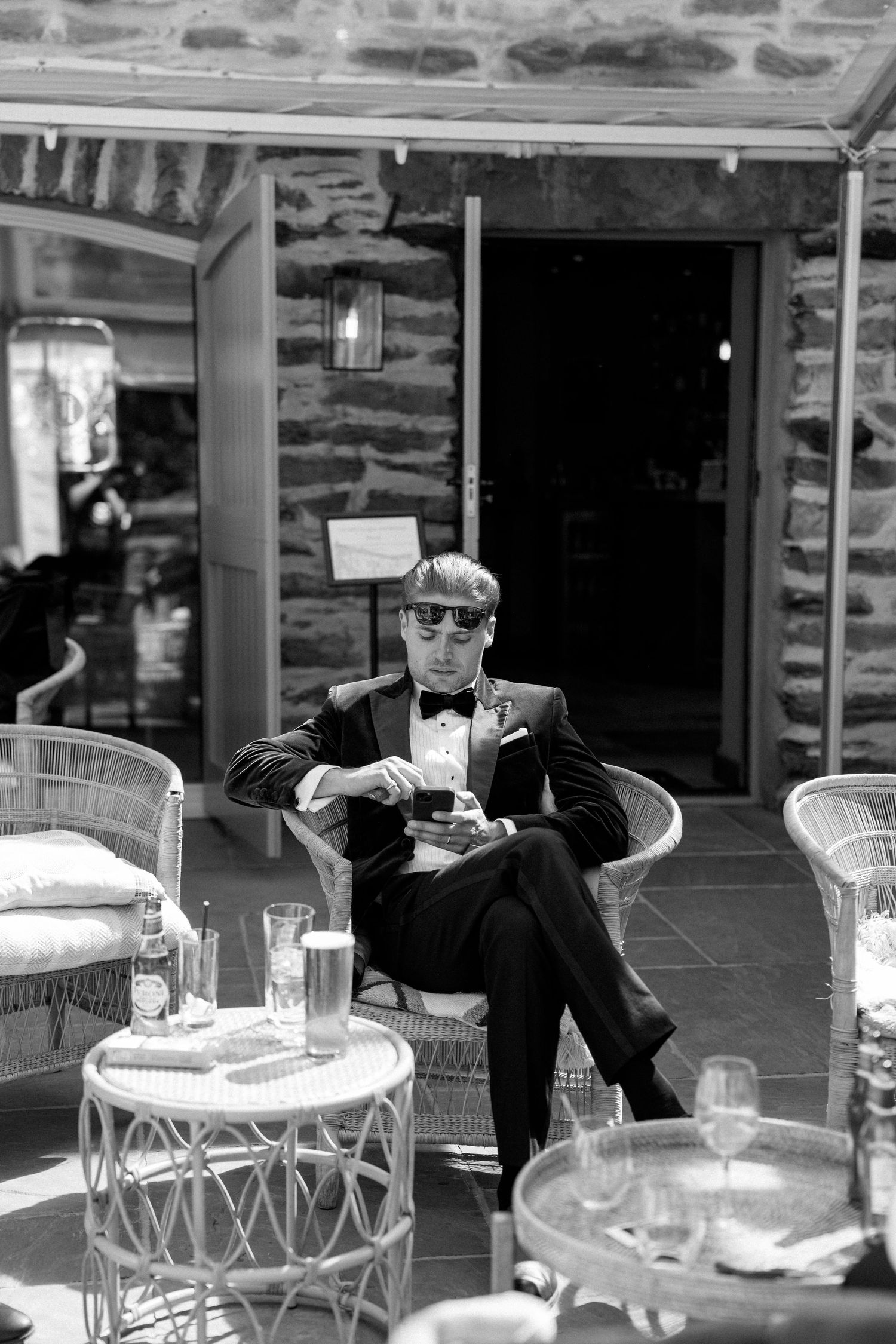 Person in formal attire relaxing on outdoor patio furniture.