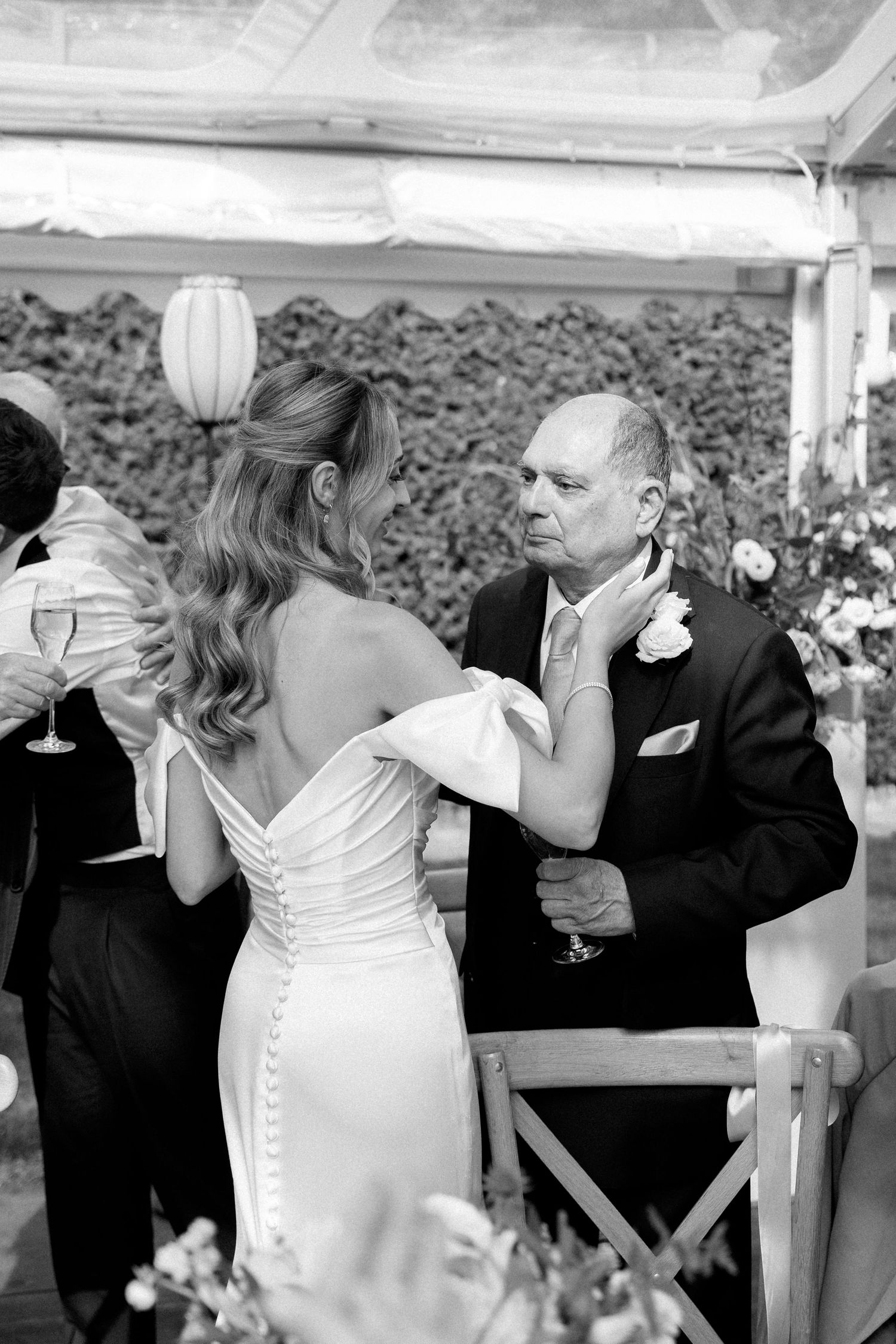Candid black and white moments captured during wedding toasts and speeches.