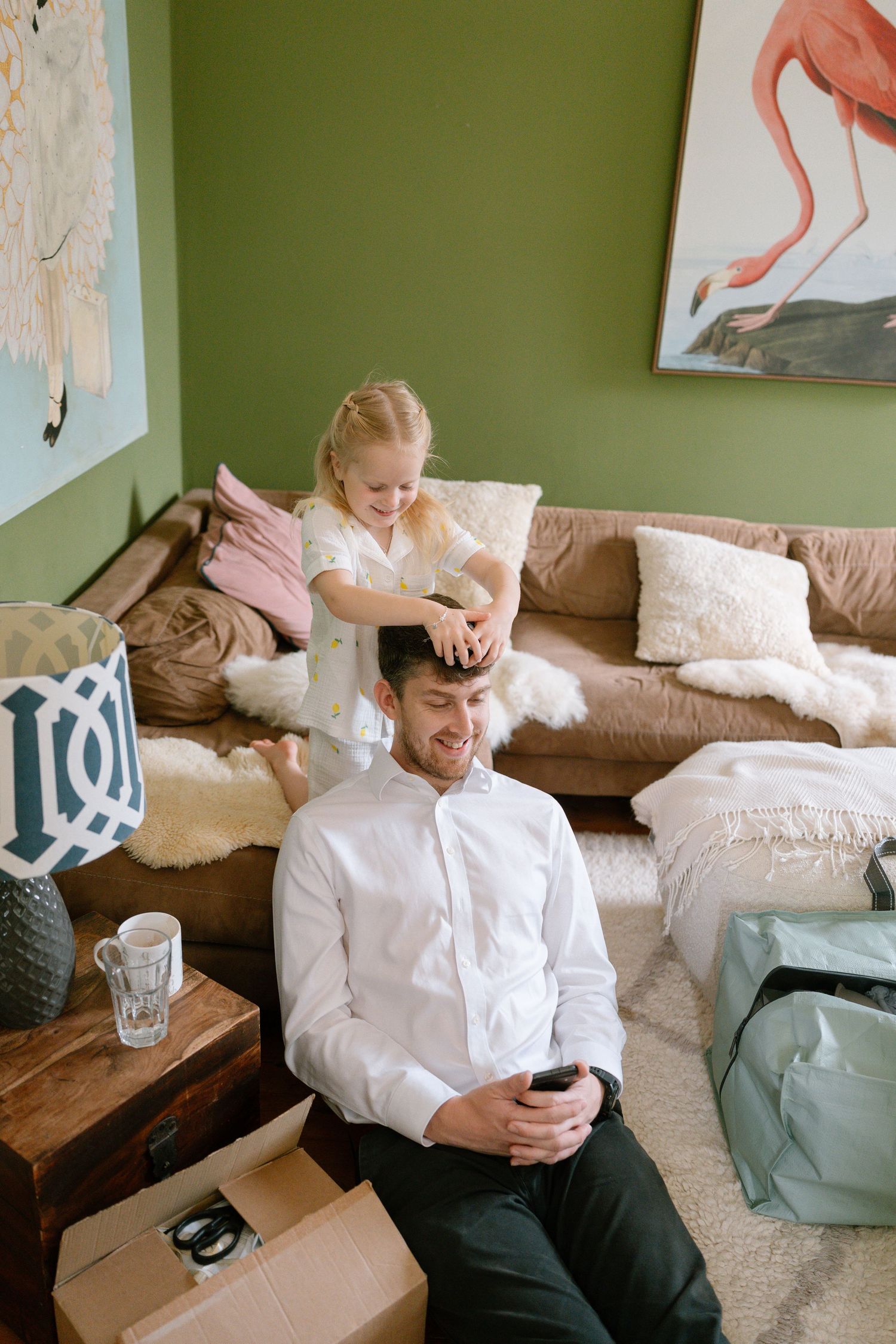 Wedding day preparations in a room with green walls.