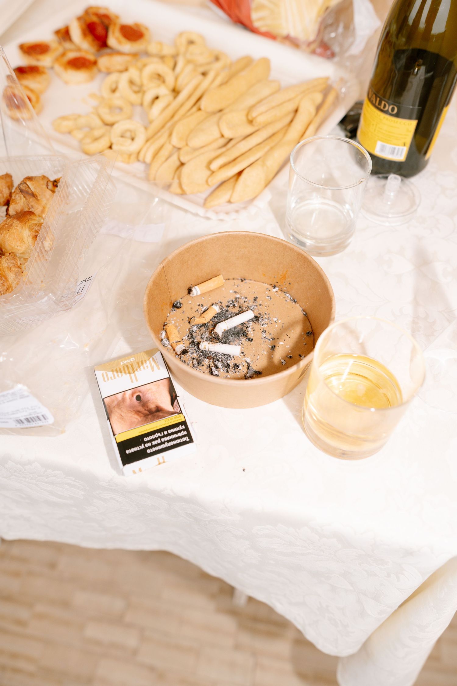 Party spread with cookies and snacks on white tablecloth.