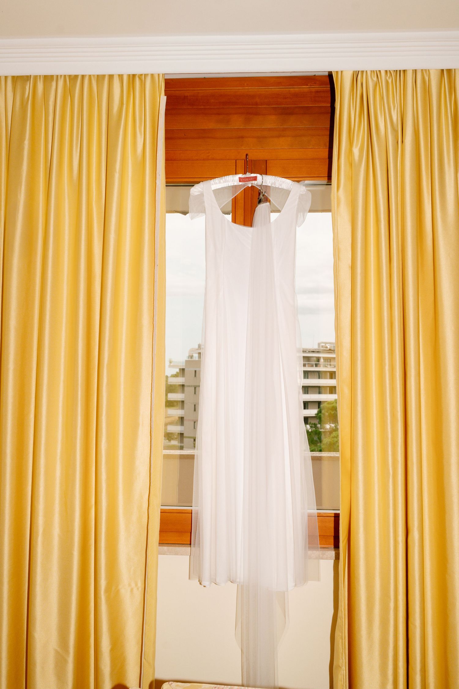 Yellow and white curtains framing windows in a bright sunny room.