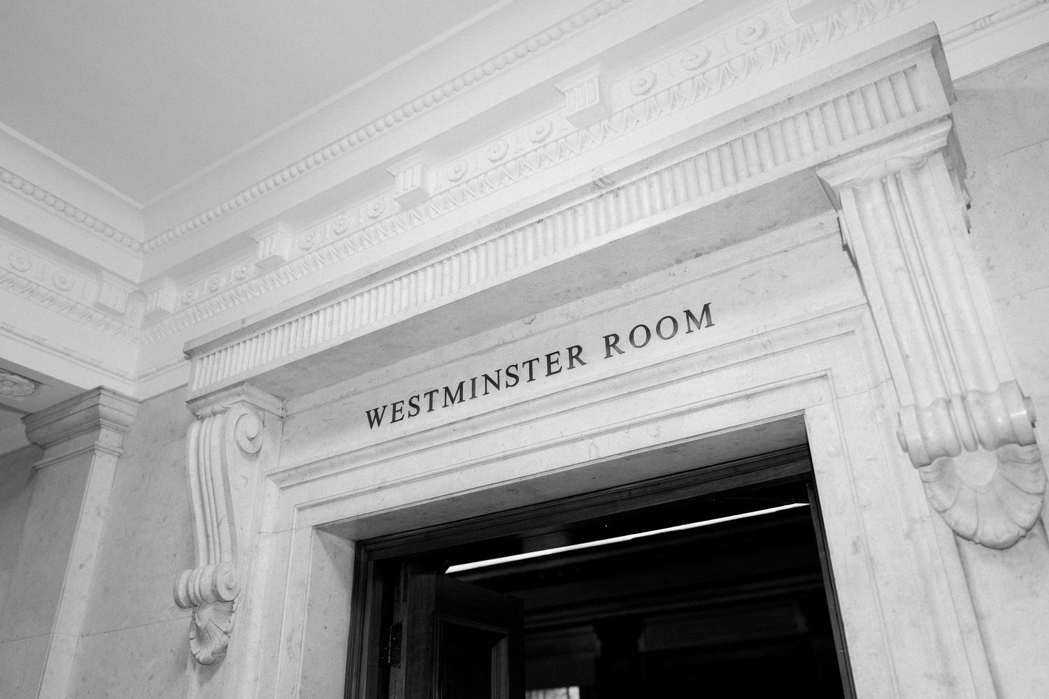 Black and white architectural detail of Westminster Room entrance with ornate molding.