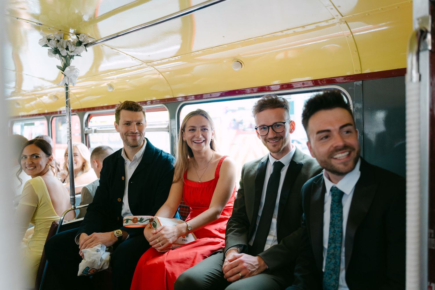 Wedding party celebrating inside a vintage bus with champagne.