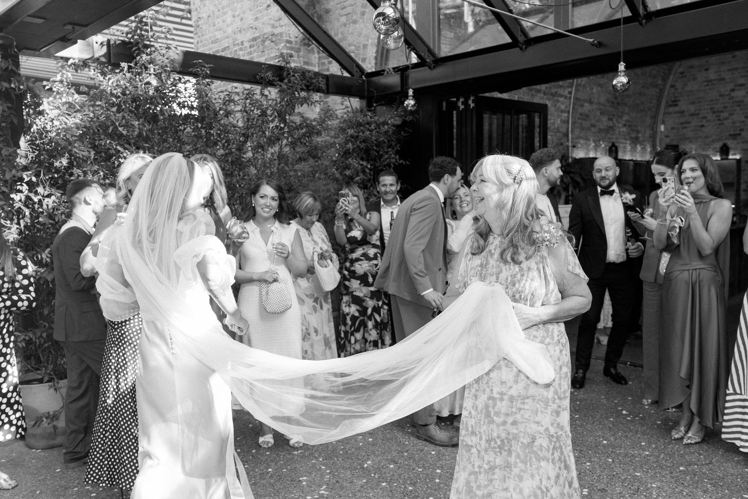 Wedding reception dance floor filled with celebrating guests in evening party atmosphere.