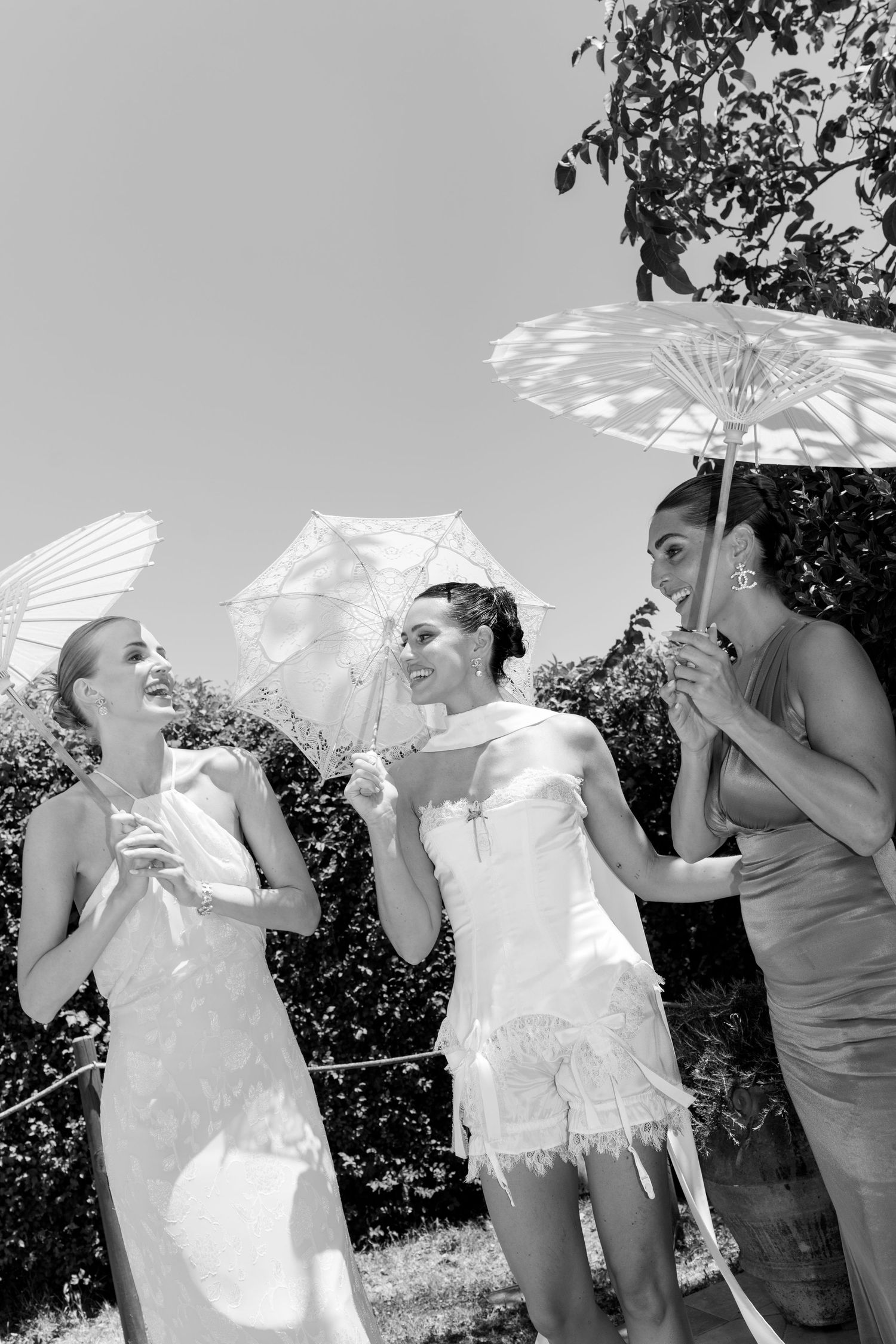A group enjoying a sunny day outdoors with decorative parasols creating playful shadows.
