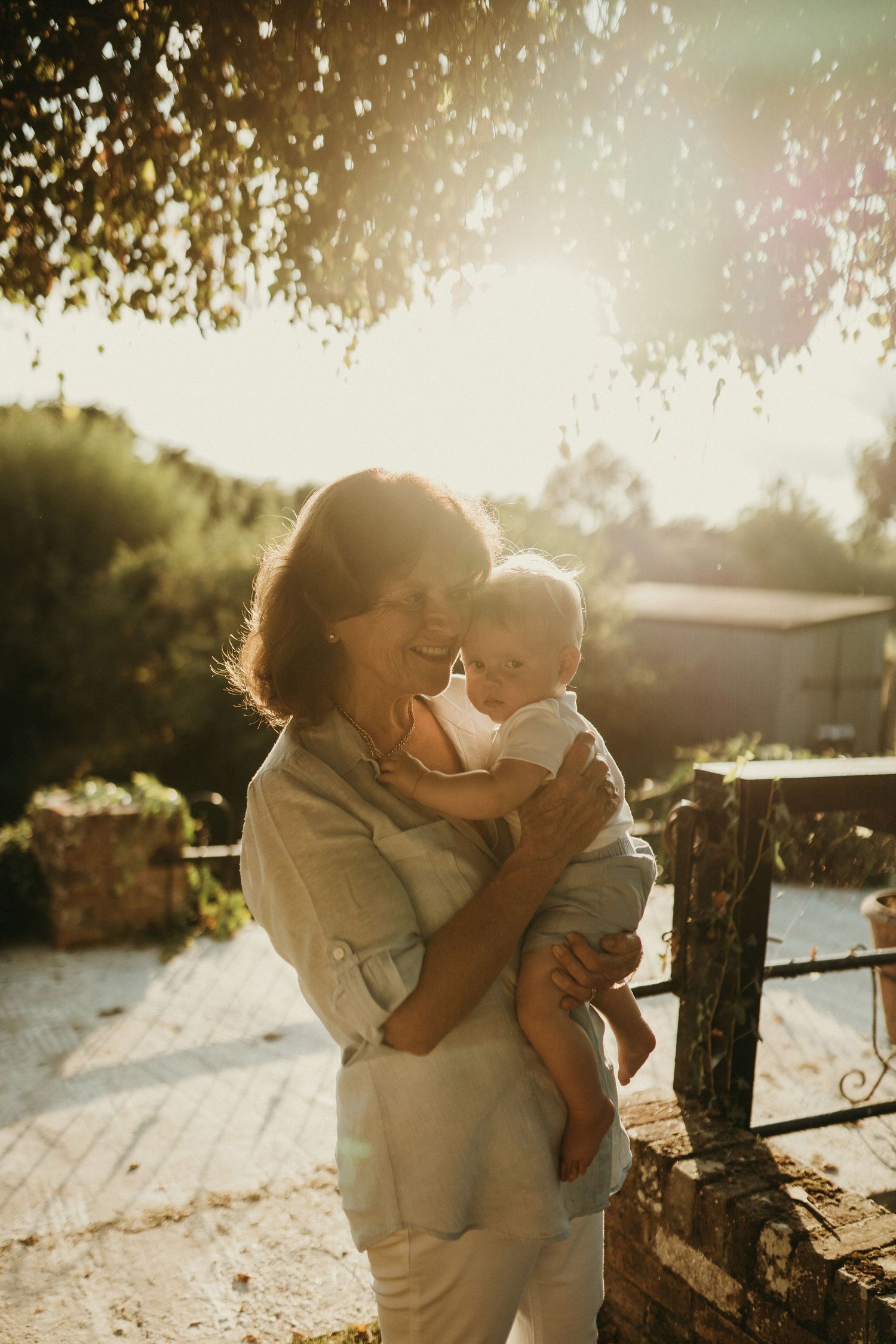 Beautiful sunset moment between family members by wooden fence.