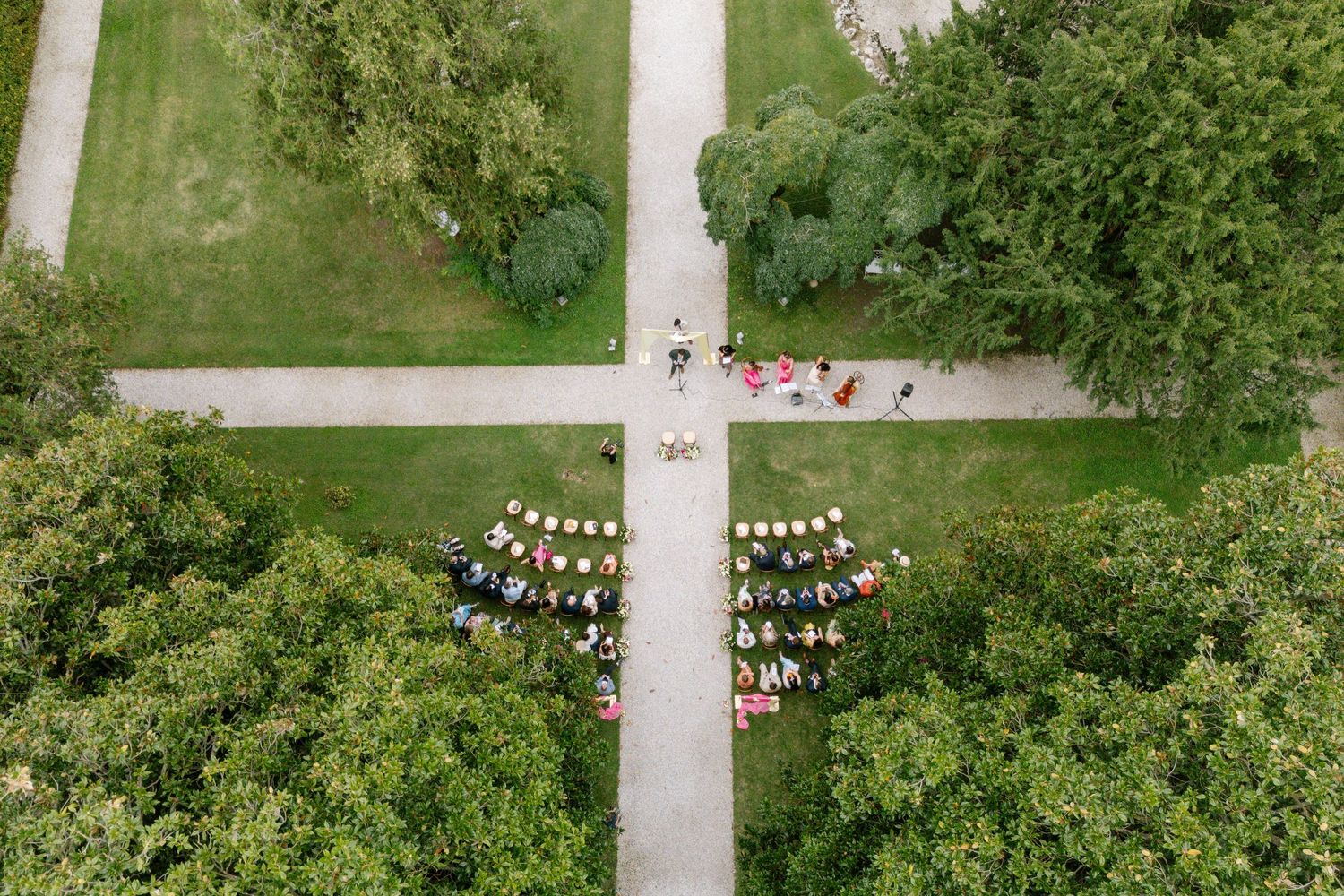 Aerial view of a garden wedding venue with manicured lawns and pathways.