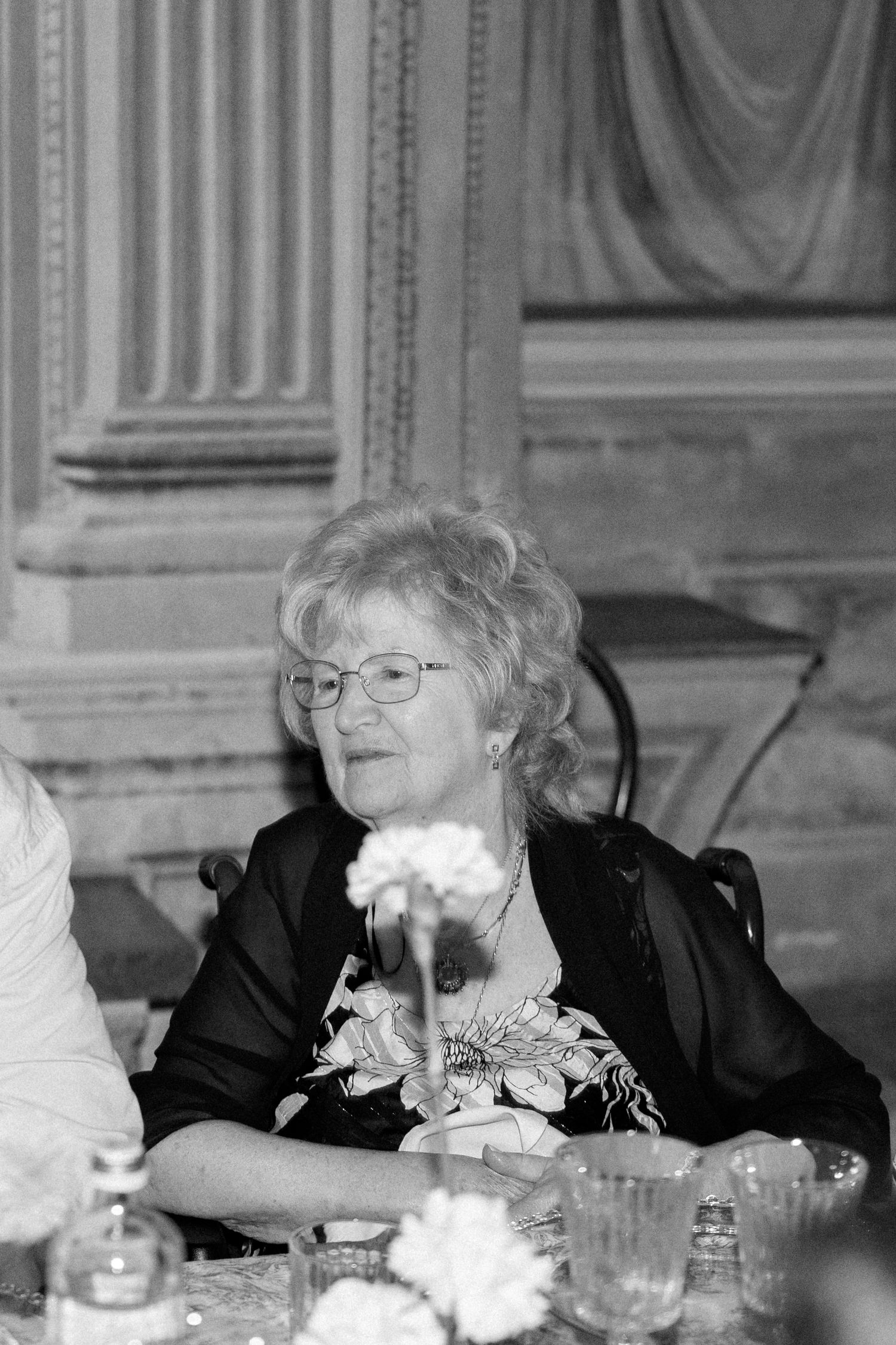Elderly guests enjoying conversation at an elegant formal dinner party.