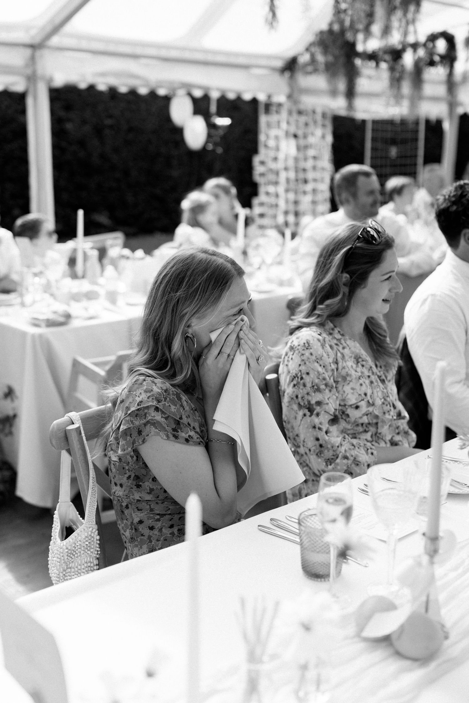 Wedding guests seated at long tables enjoying the reception festivities.