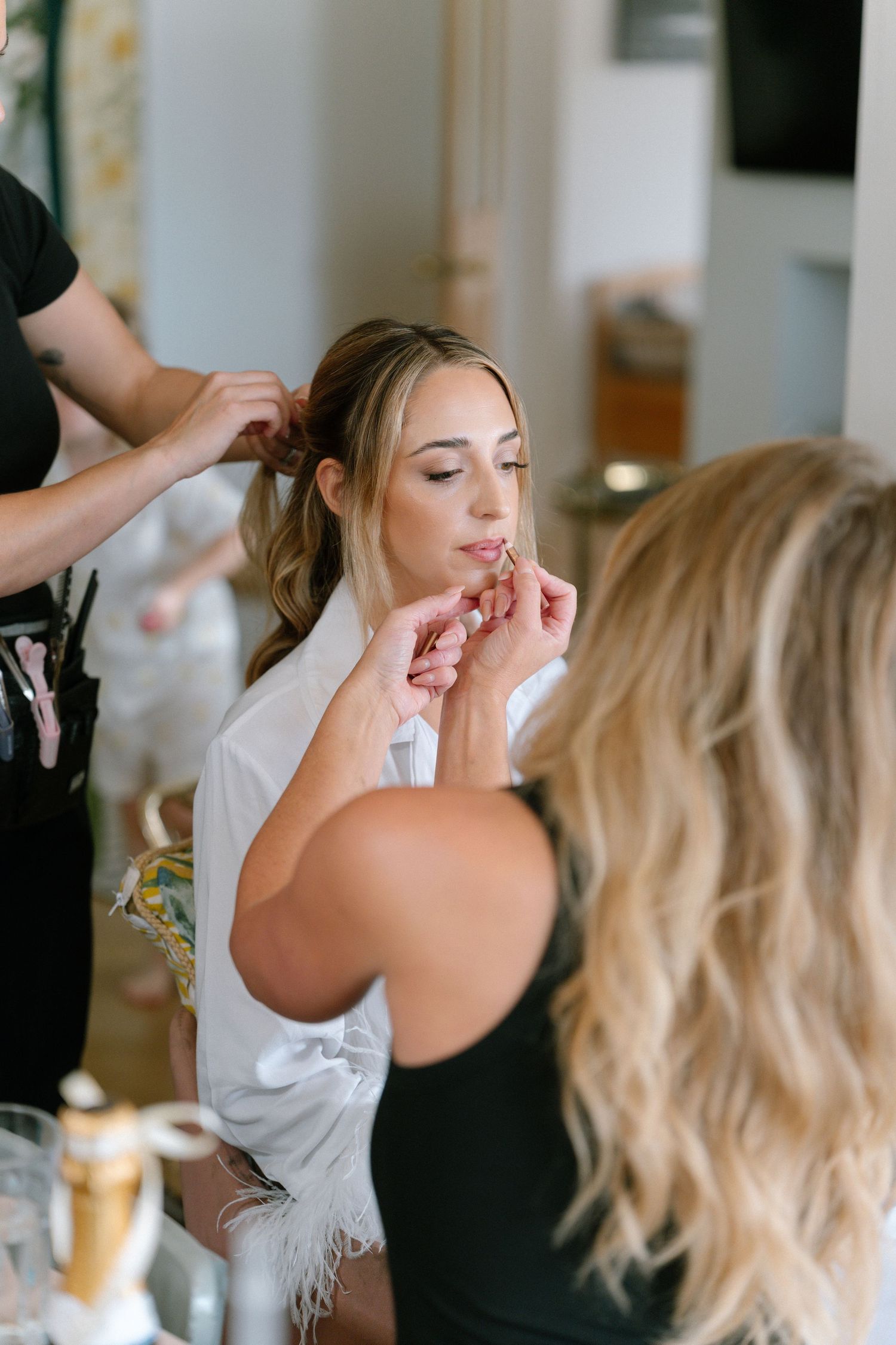 Professional hair and makeup preparation session in progress.