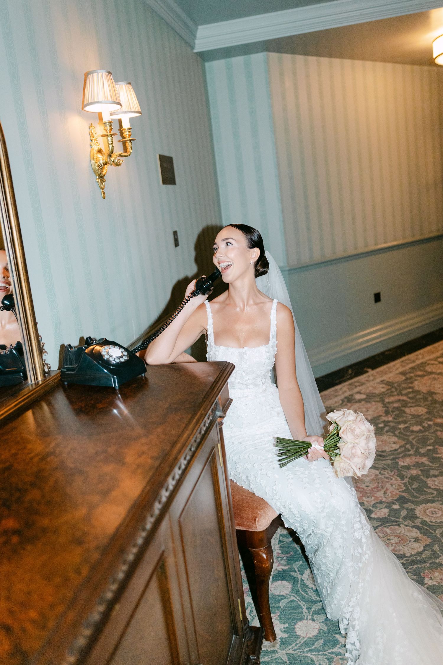 Series showing a bride leaning and posing against wooden paneling in an elegant hallway.
