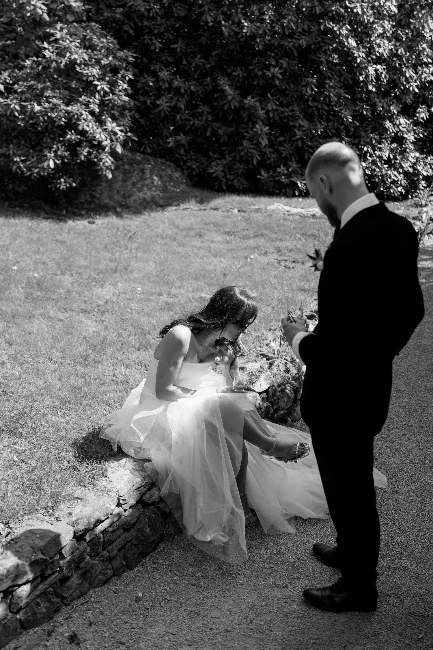 A dramatic wedding photo series showing tender moments between newlyweds on grassy grounds.