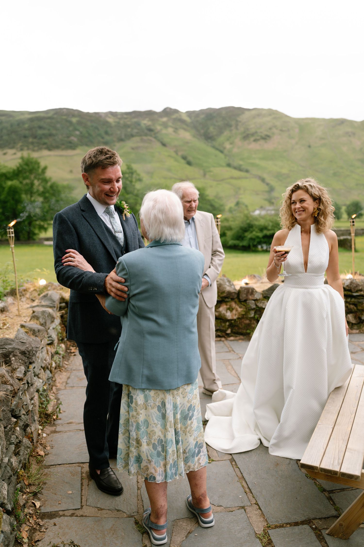 Wedding celebration on a stone patio with mountains in the background.