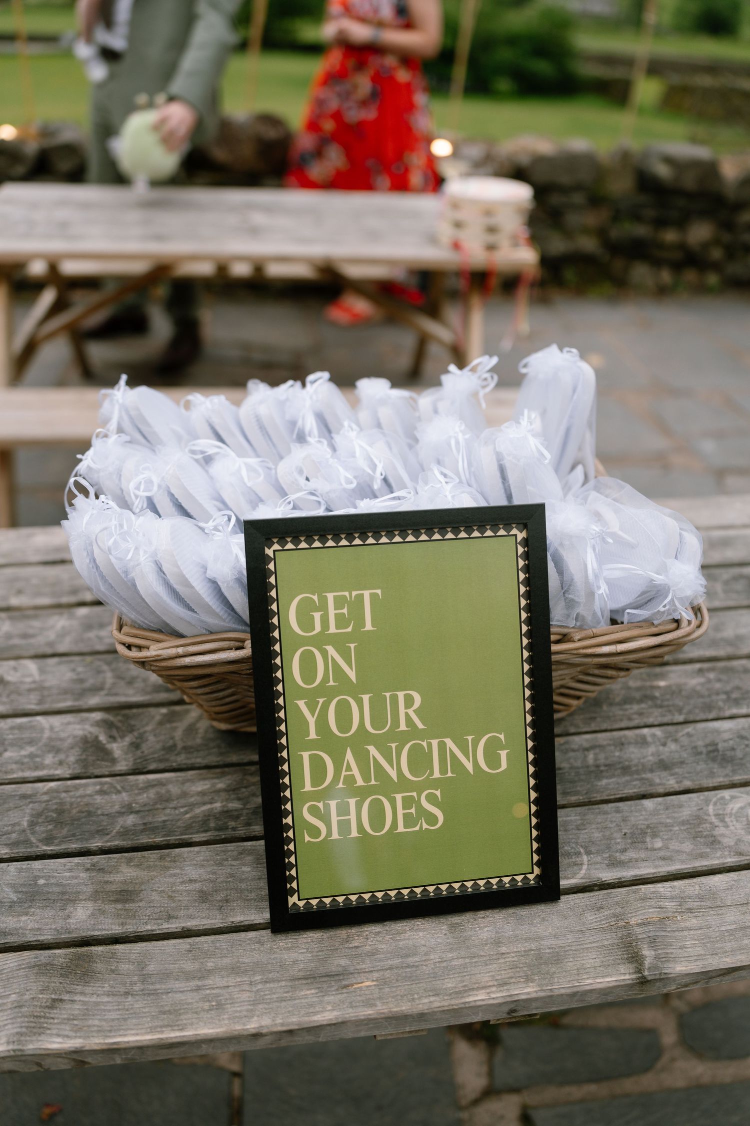 Wedding reception signs on wooden table say Get Your Dancing Shoes.