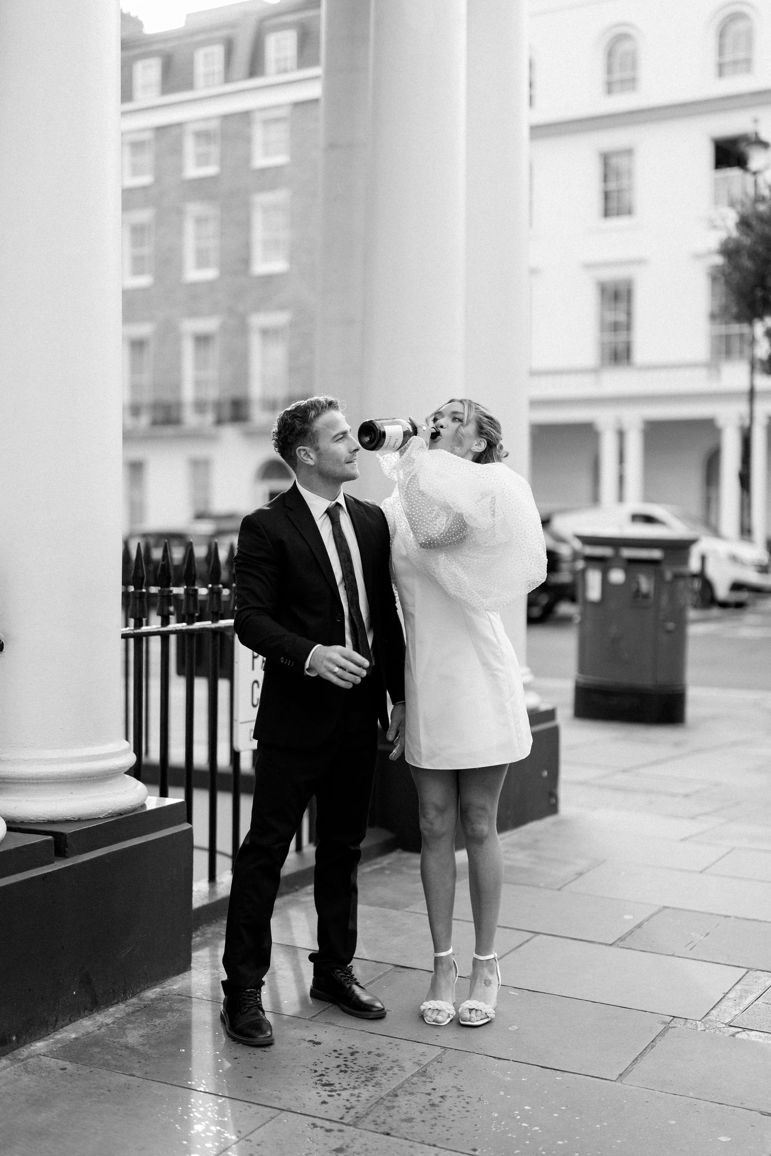 Romantic sequence showing playful interactions between a couple near white columns.