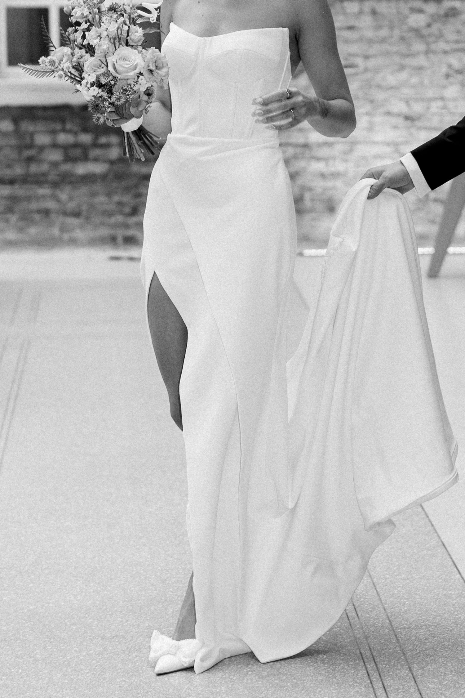 A series of black and white wedding photos showing close-up details of white bridal gowns and bouquets.
