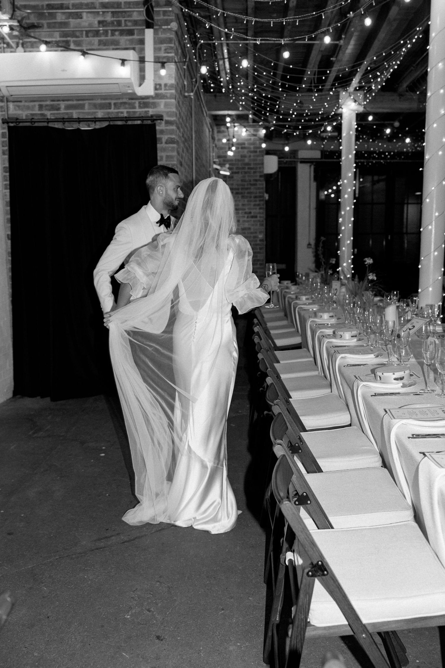 Black and white reception photos show couples dancing under twinkling string lights.